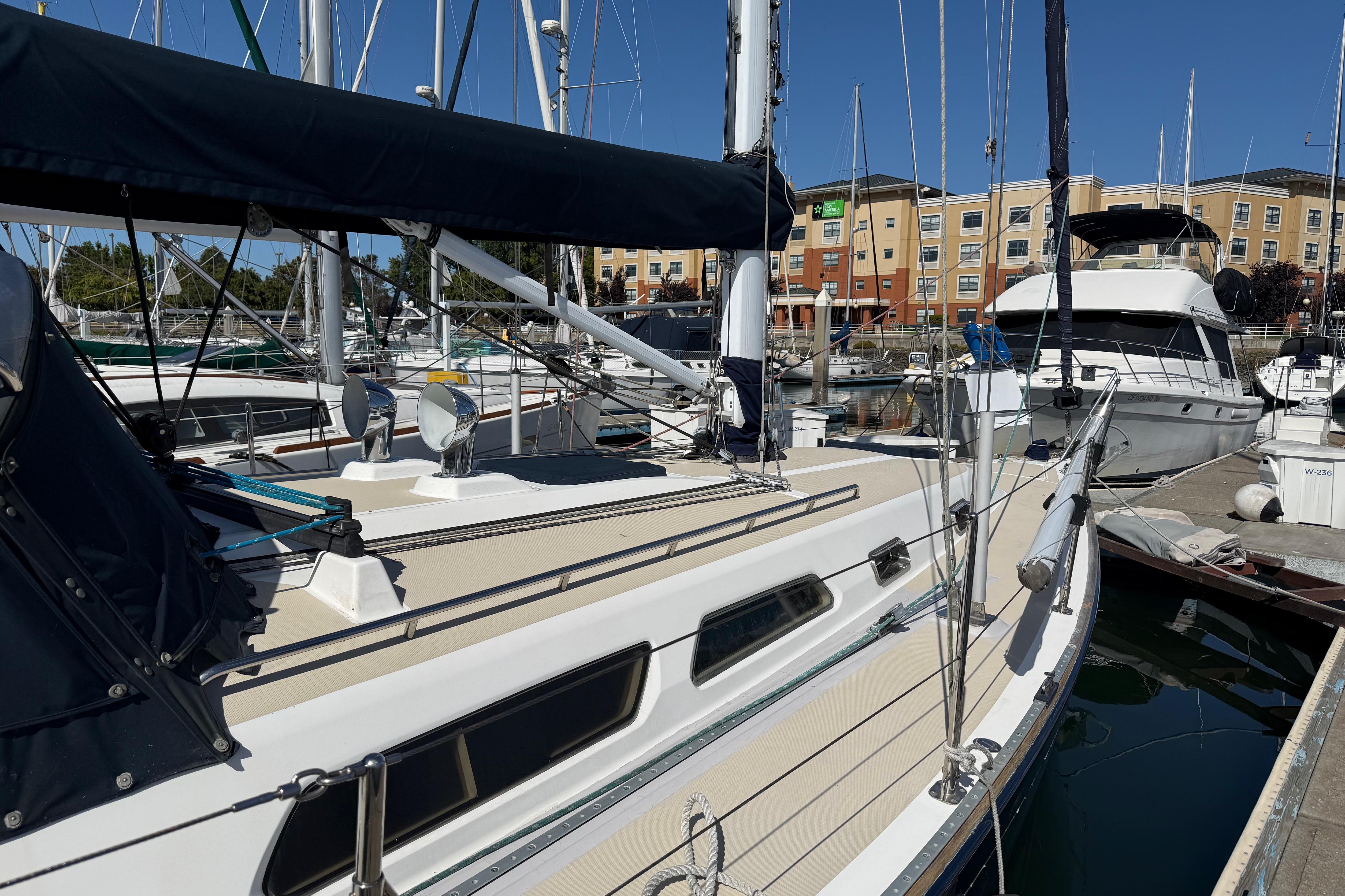 2004 Sabre 386 sailboat docked at marina under clear blue sky.
