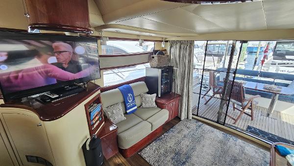 Luxurious interior of 2005 Neptunus 56 Flybridge yacht with cozy seating and entertainment area.