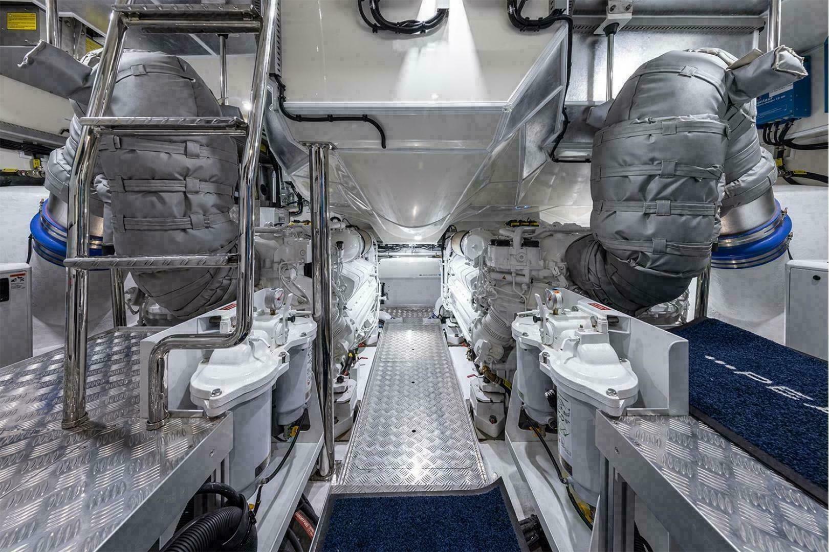 Engine room of 2023 Pearl 72 yacht, featuring advanced machinery and metallic finishes.