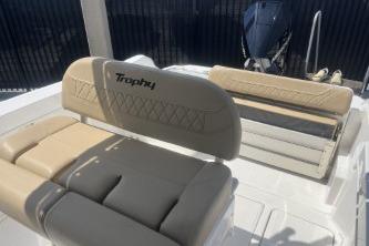 2023 Trophy T24 CC boat interior with beige seating and motor.