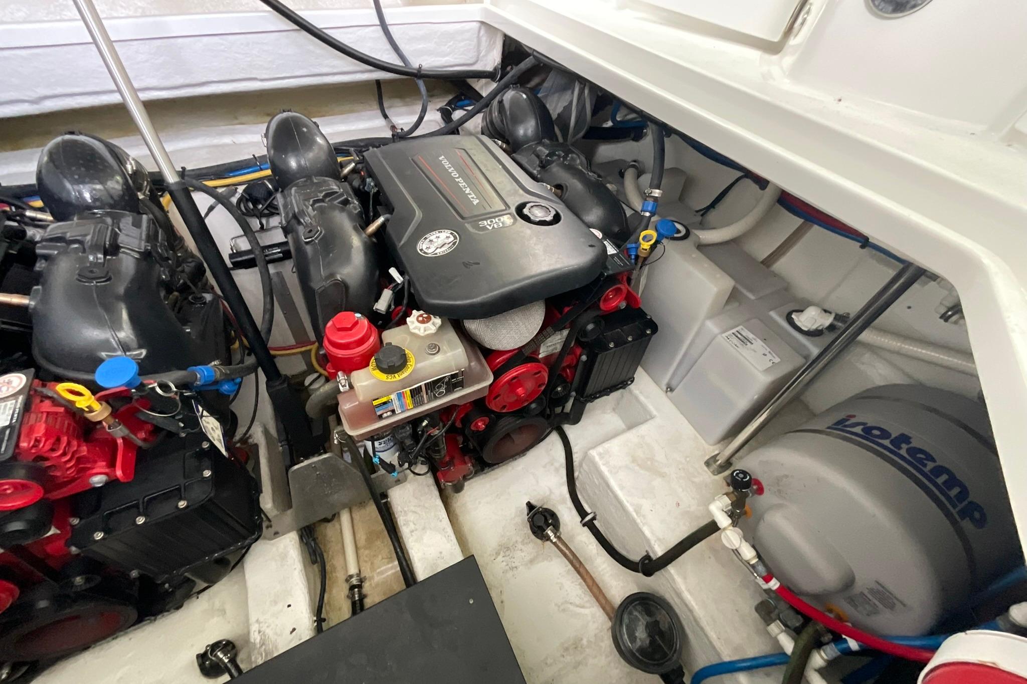 Engine room of a 2019 Monterey 335 Sport Yacht, showcasing dual engines and mechanical components.