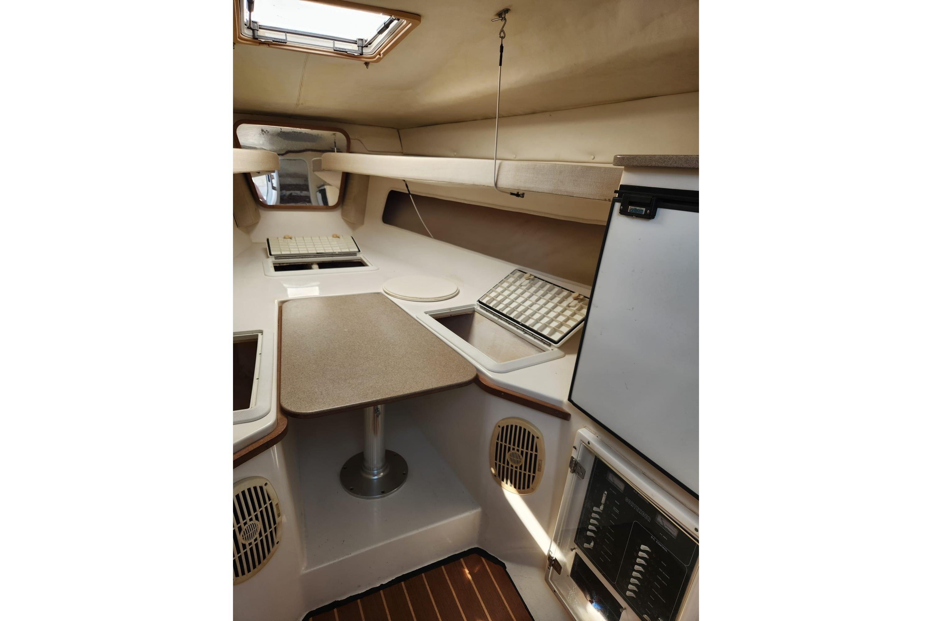 2008 Contender 35 Express Side Console interior with table, storage, and appliances.