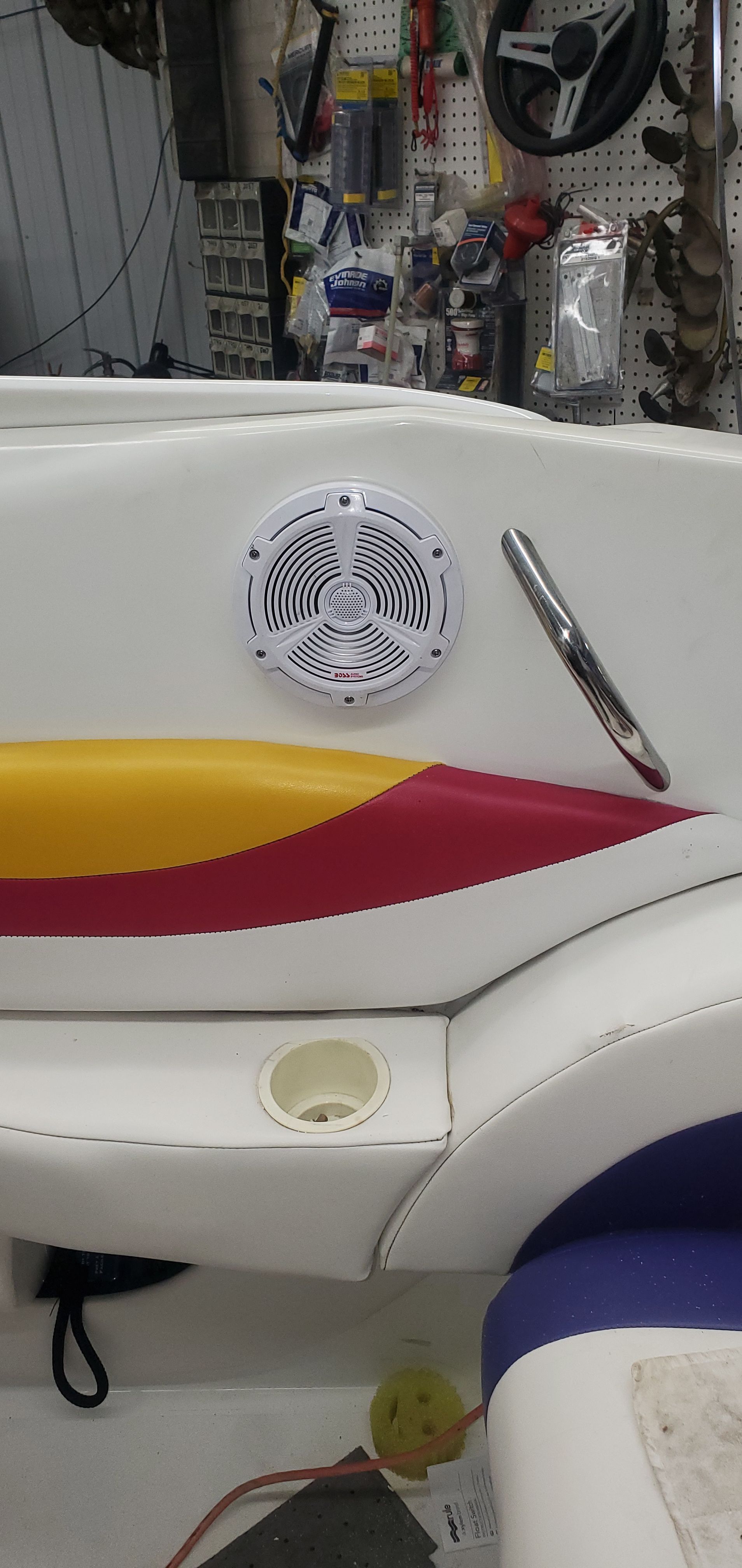 The image shows the interior of a 1996 Baja 302 Boss boat with colorful seats and a speaker.
