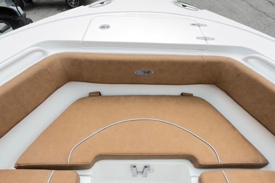 2026 Sea Hunt Ultra 255 SE boat interior with tan cushioned seating.