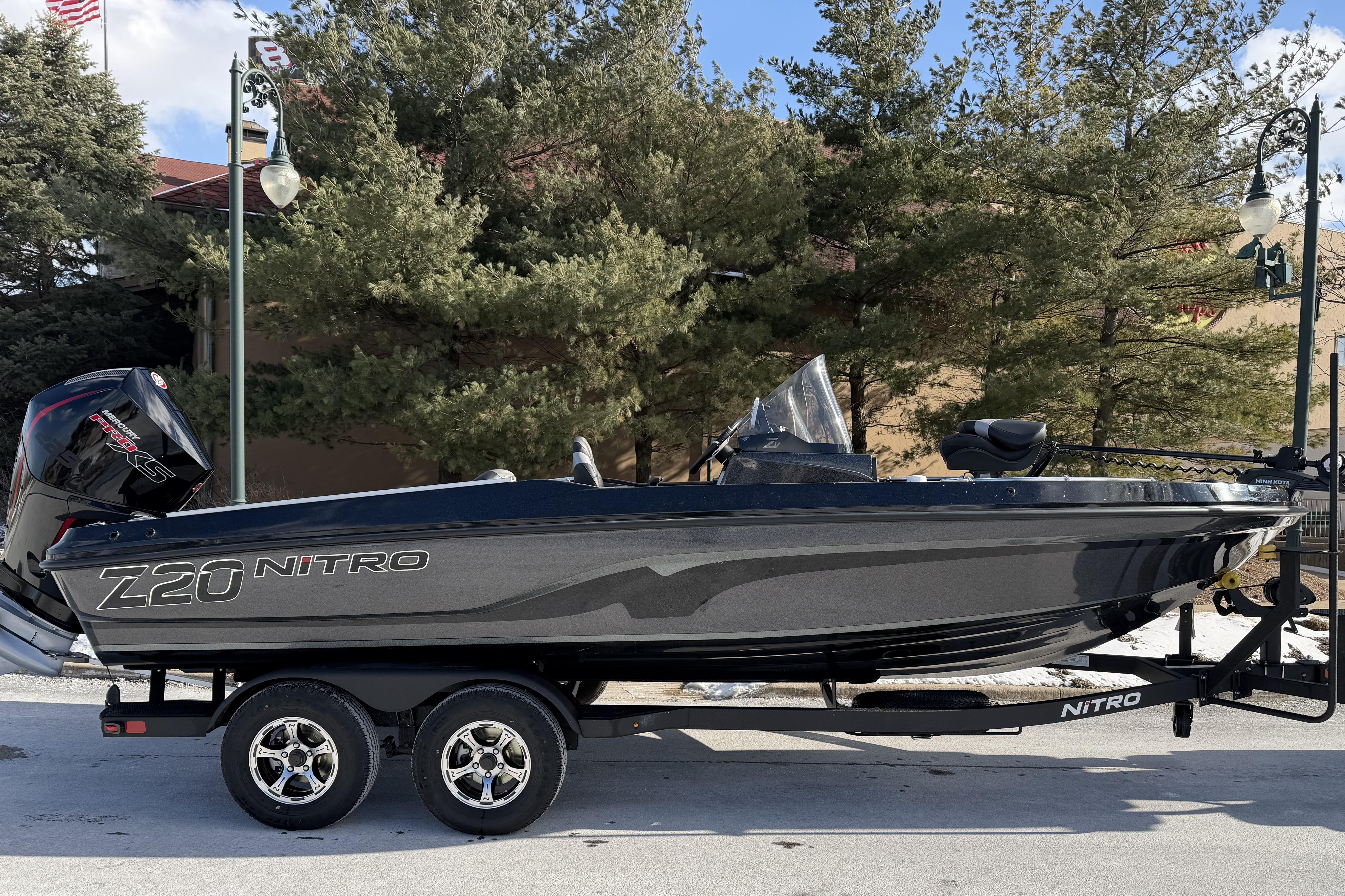 2026 Nitro ZV20 boat on trailer, parked outdoors with trees in background.