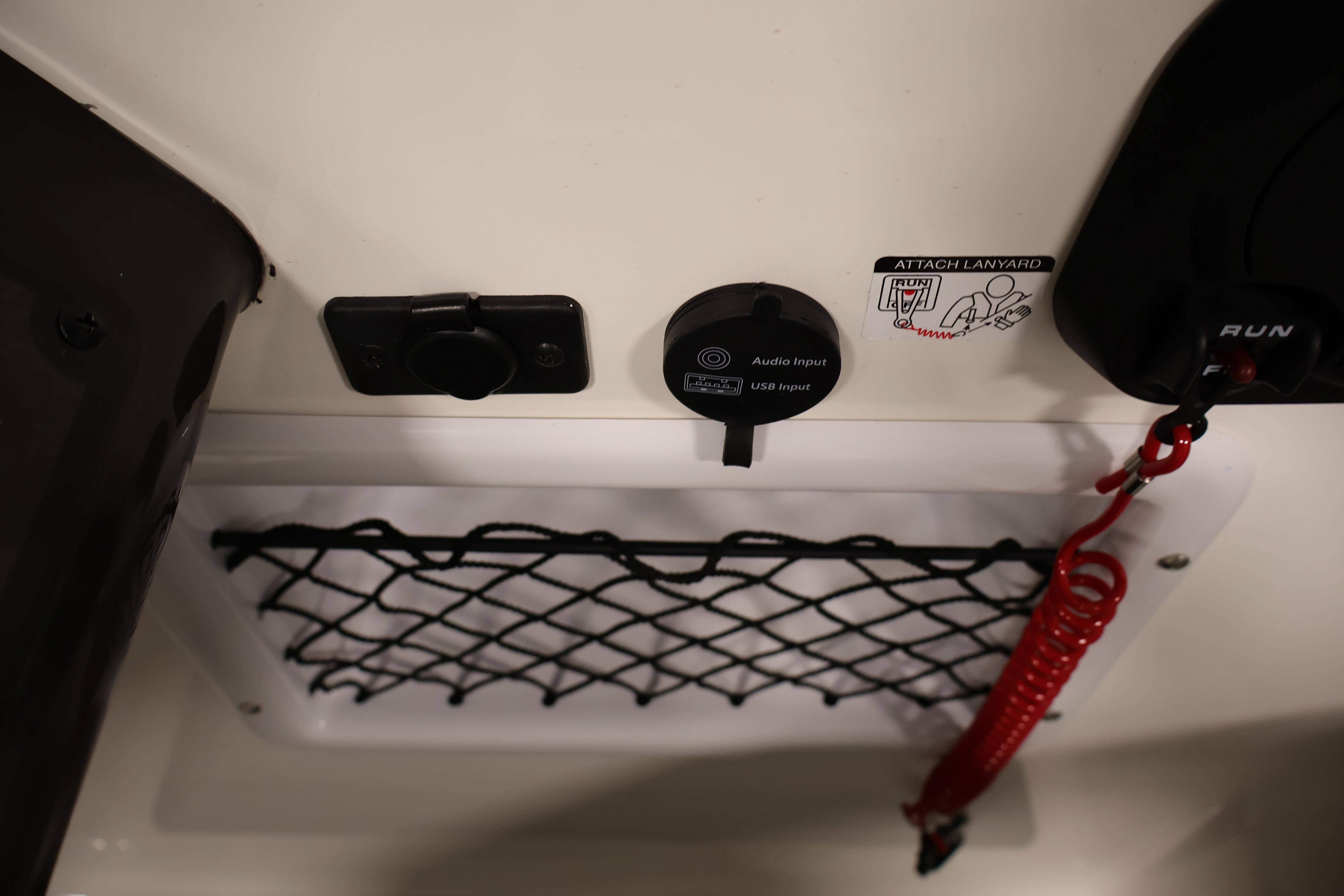 2026 Bayliner VR6 Bowrider I/O dashboard with audio input, USB port, and safety lanyard.