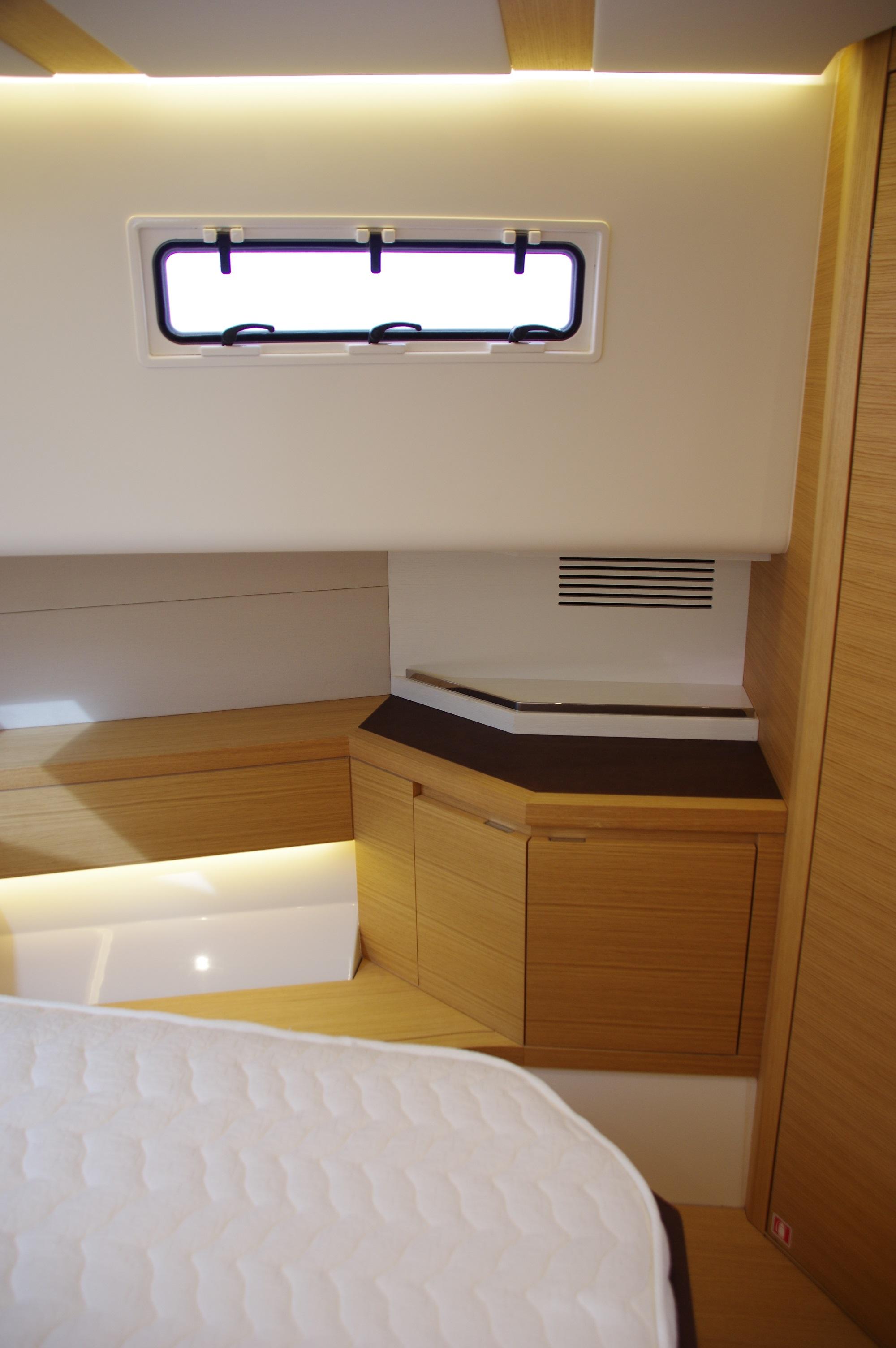 Interior cabin of 2025 Pardo Yachts 50, featuring modern wood finishes and ambient lighting.