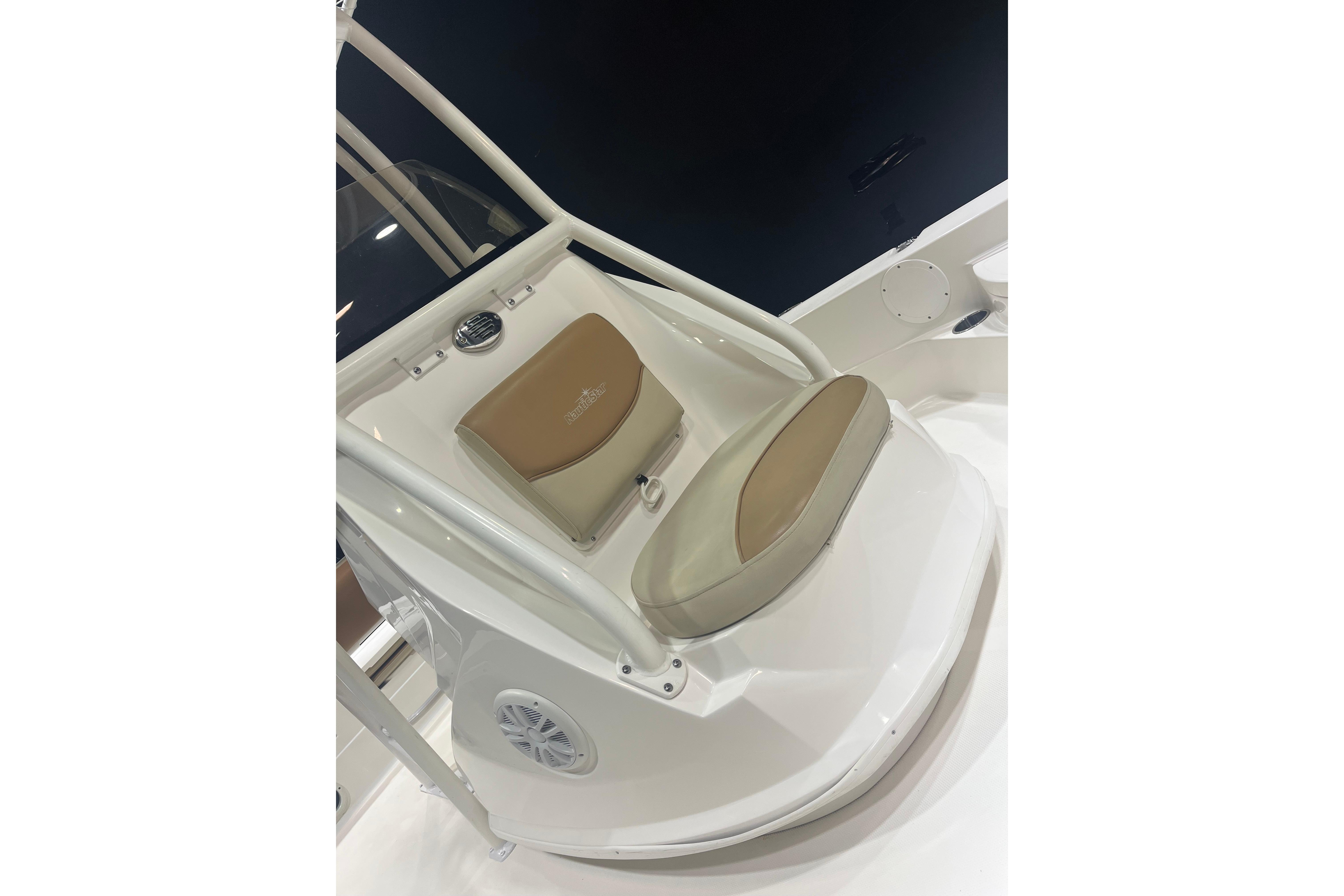 2023 NauticStar 227 XTS boat seat with beige cushion and white frame.