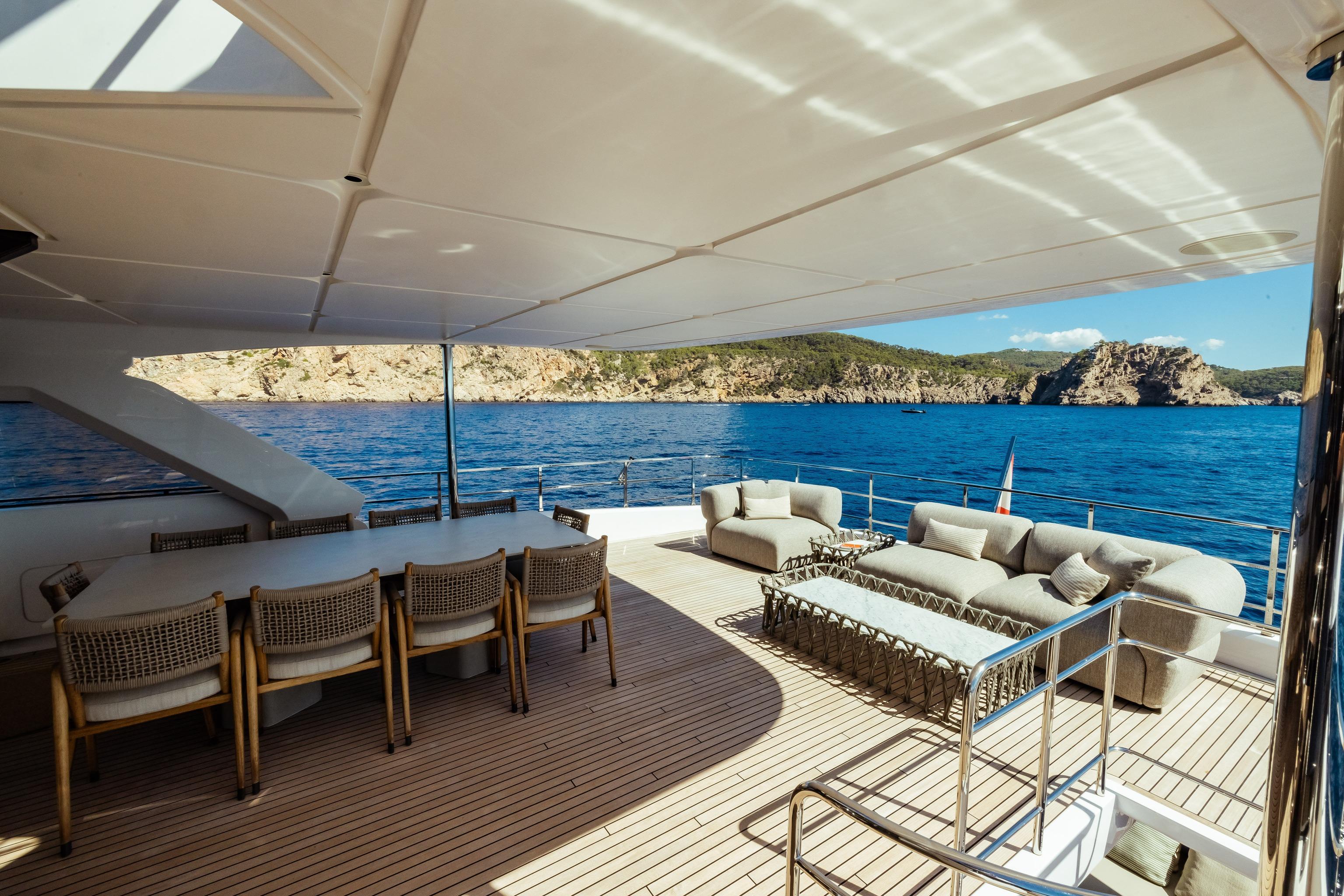 Luxurious 2022 Custom Line Navetta 30 yacht deck with elegant seating and ocean view.