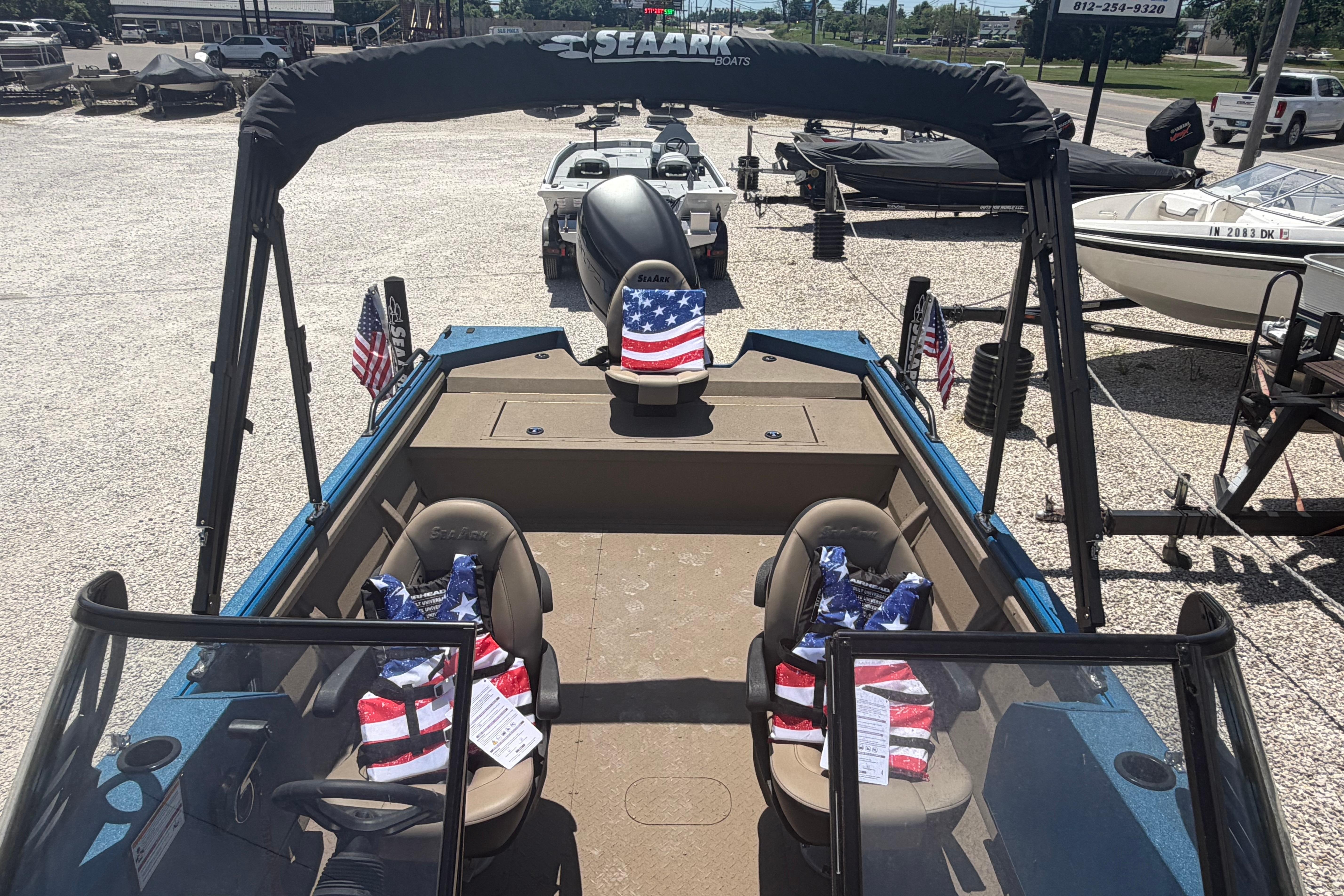 2025 SeaArk Protege 240 boat with American flag-themed seats, displayed outdoors.