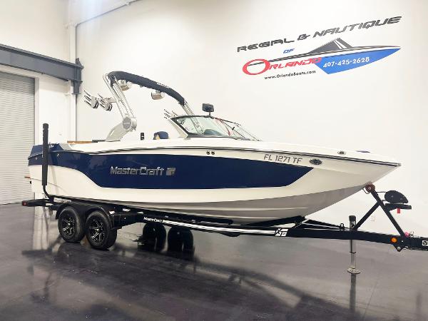 2022 MasterCraft NXT24 boat on trailer in showroom.