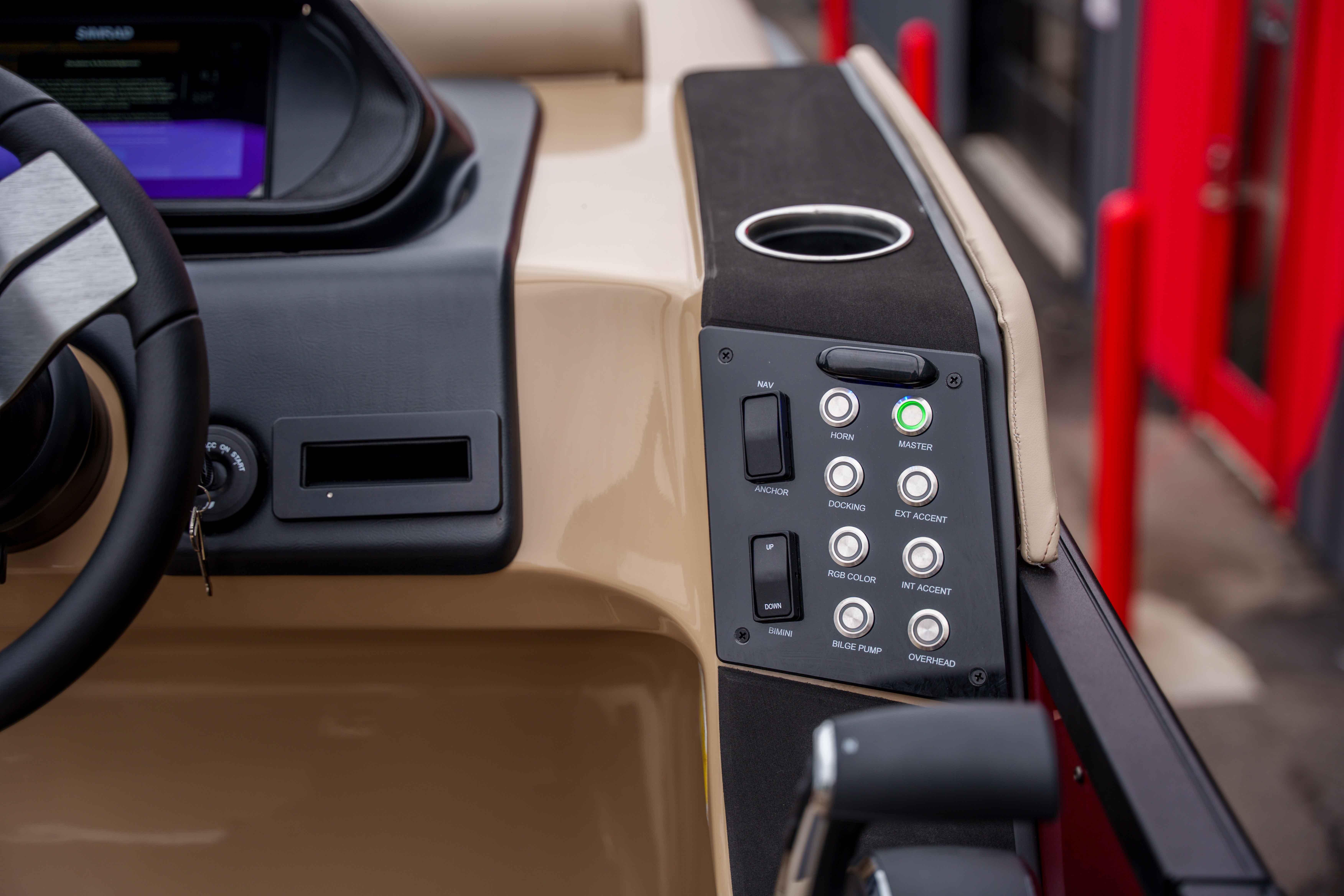Dashboard controls of 2026 Harris Sunliner 230 boat, featuring steering wheel and control panel.