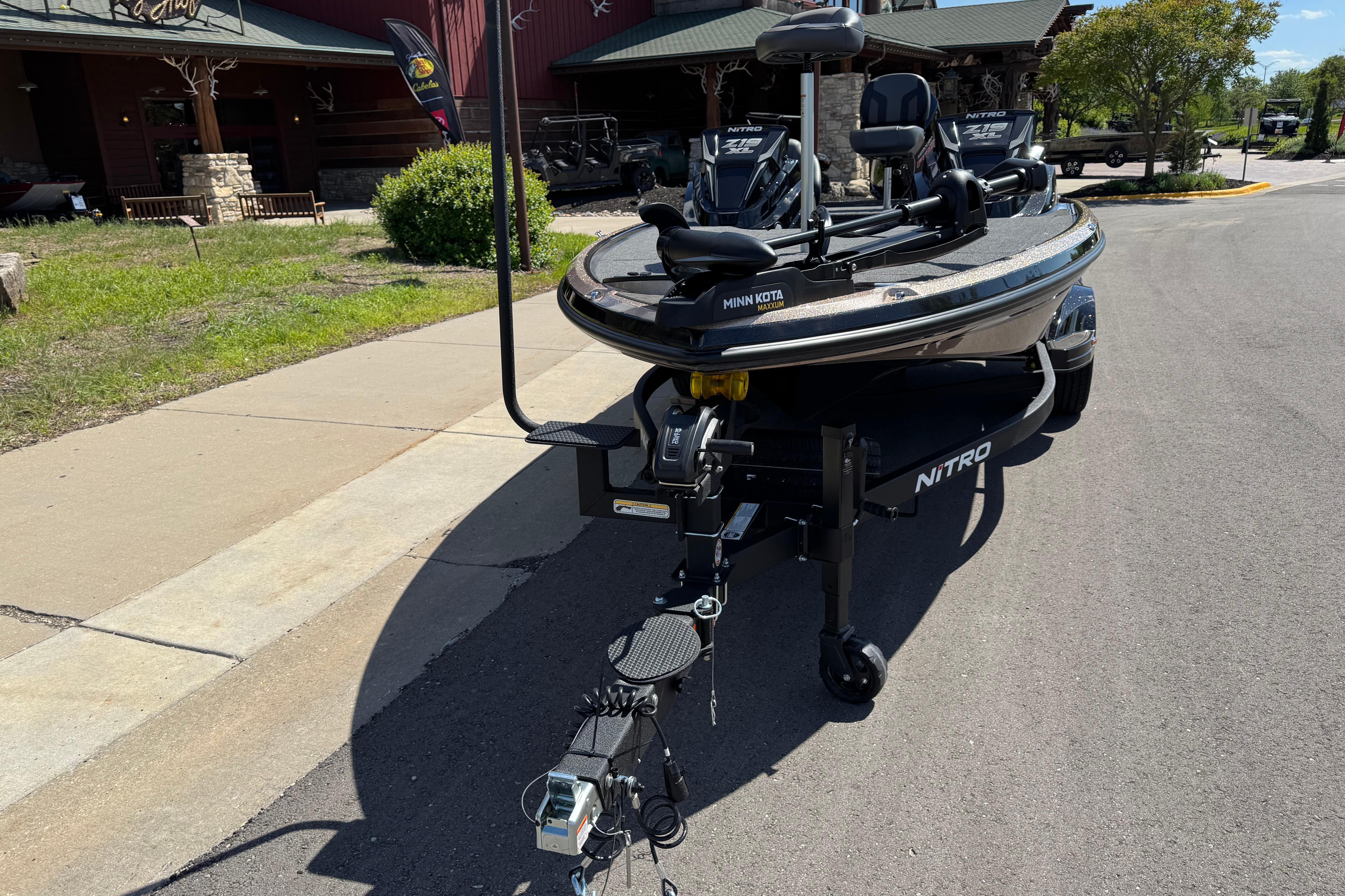 2026 Nitro Z19 XL fishing boat parked outside a rustic building.