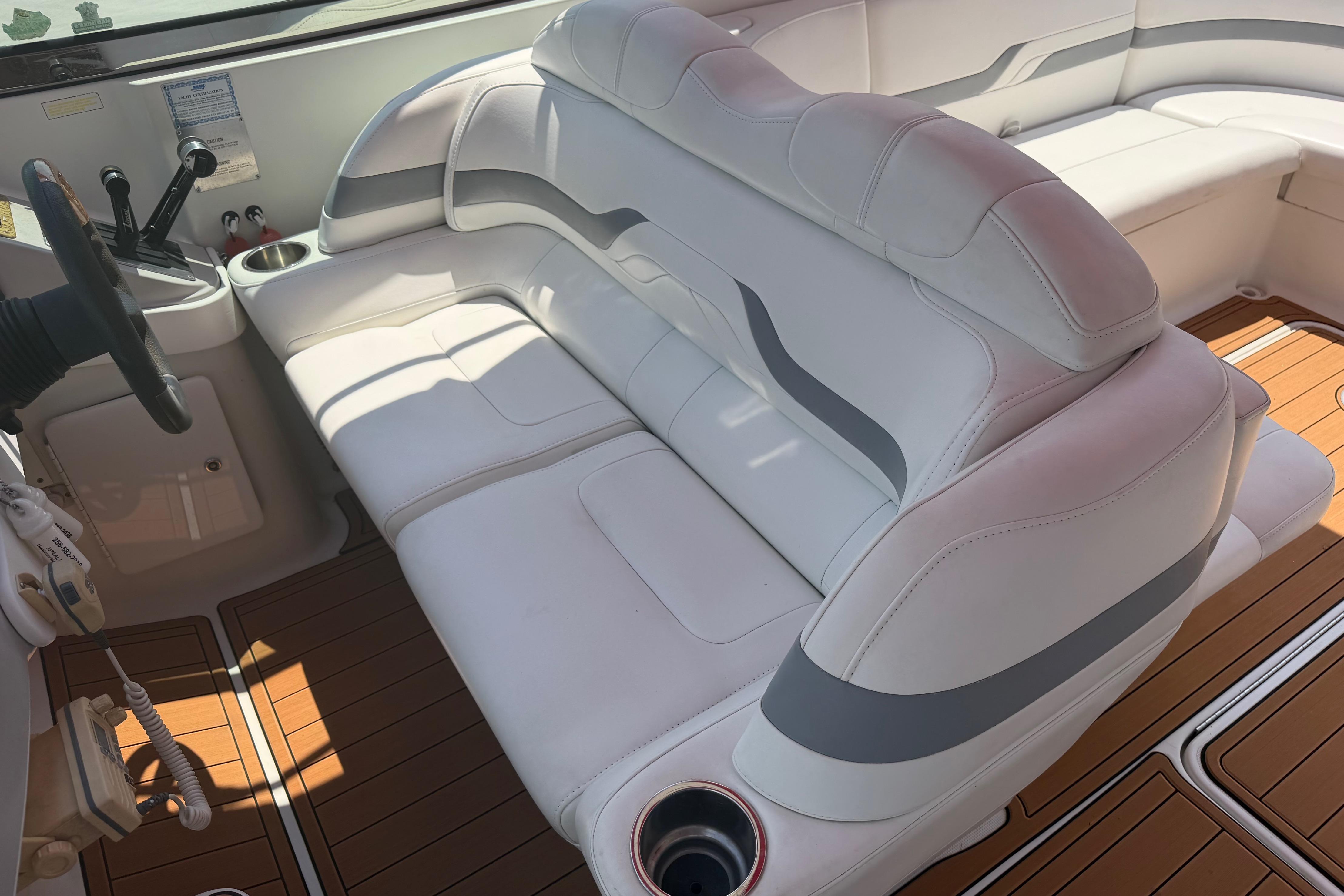 2006 Formula 330 Sun Sport boat interior with white seating and wood flooring.