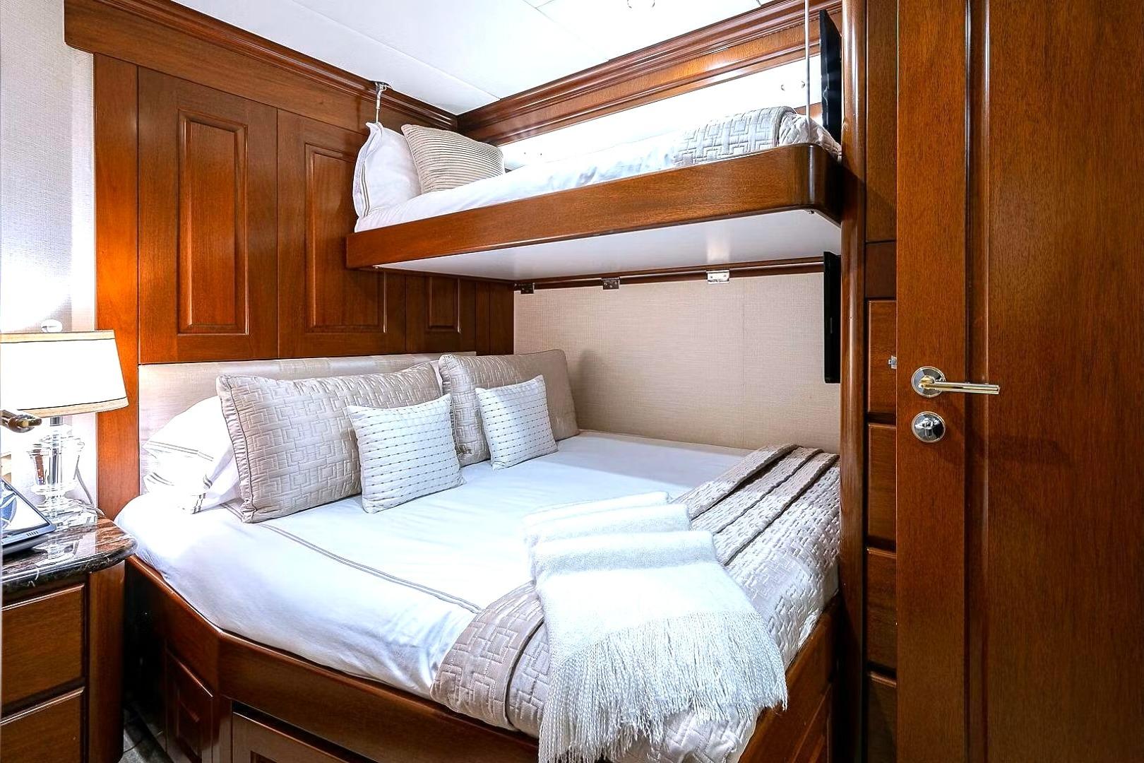 Luxurious cabin interior of 2000 Christensen Raised Pilothouse yacht with wooden finishes.