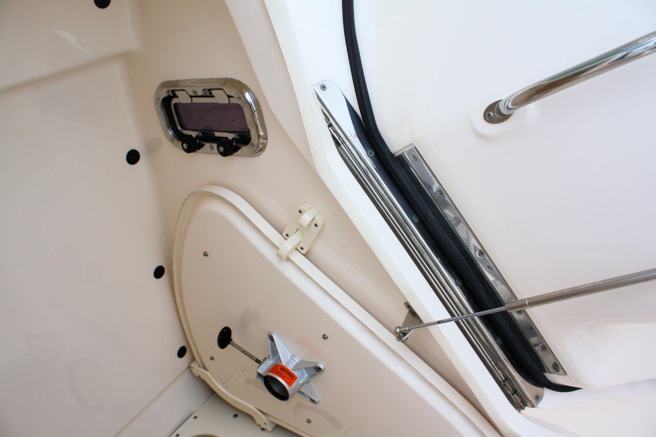 Interior view of a 2013 Pursuit ST 310 Sport boat, featuring a hatch and handle.