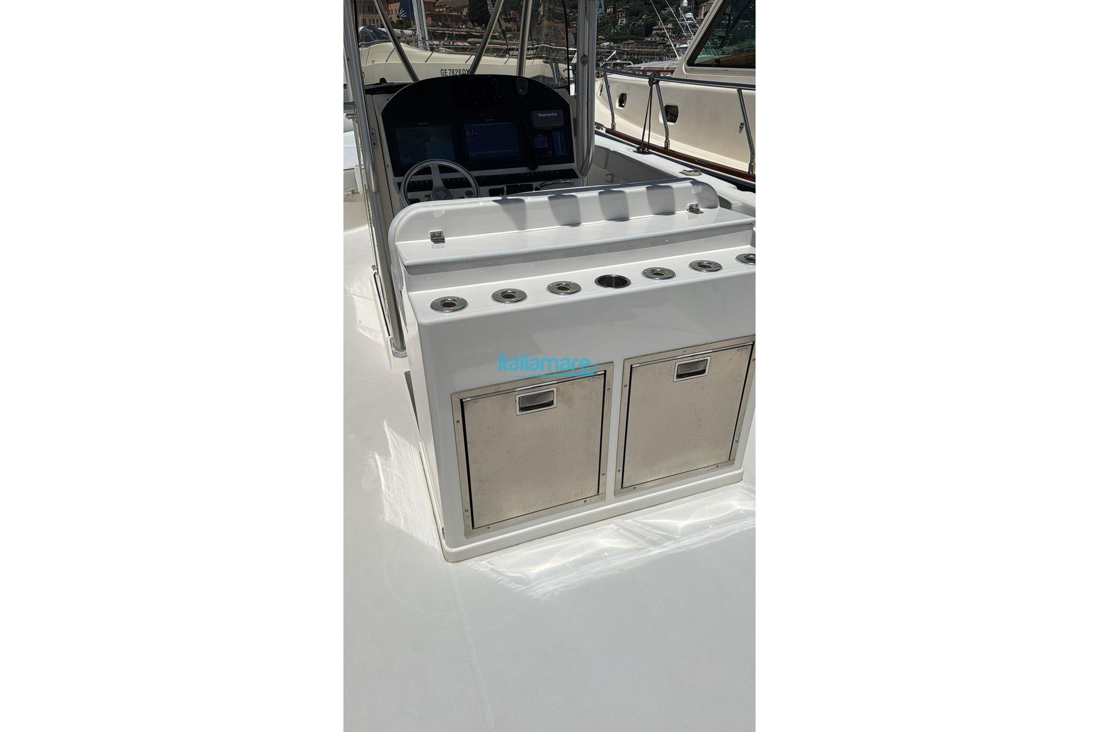2010 Wellcraft 35 Scarab Sport boat console with storage and steering wheel.