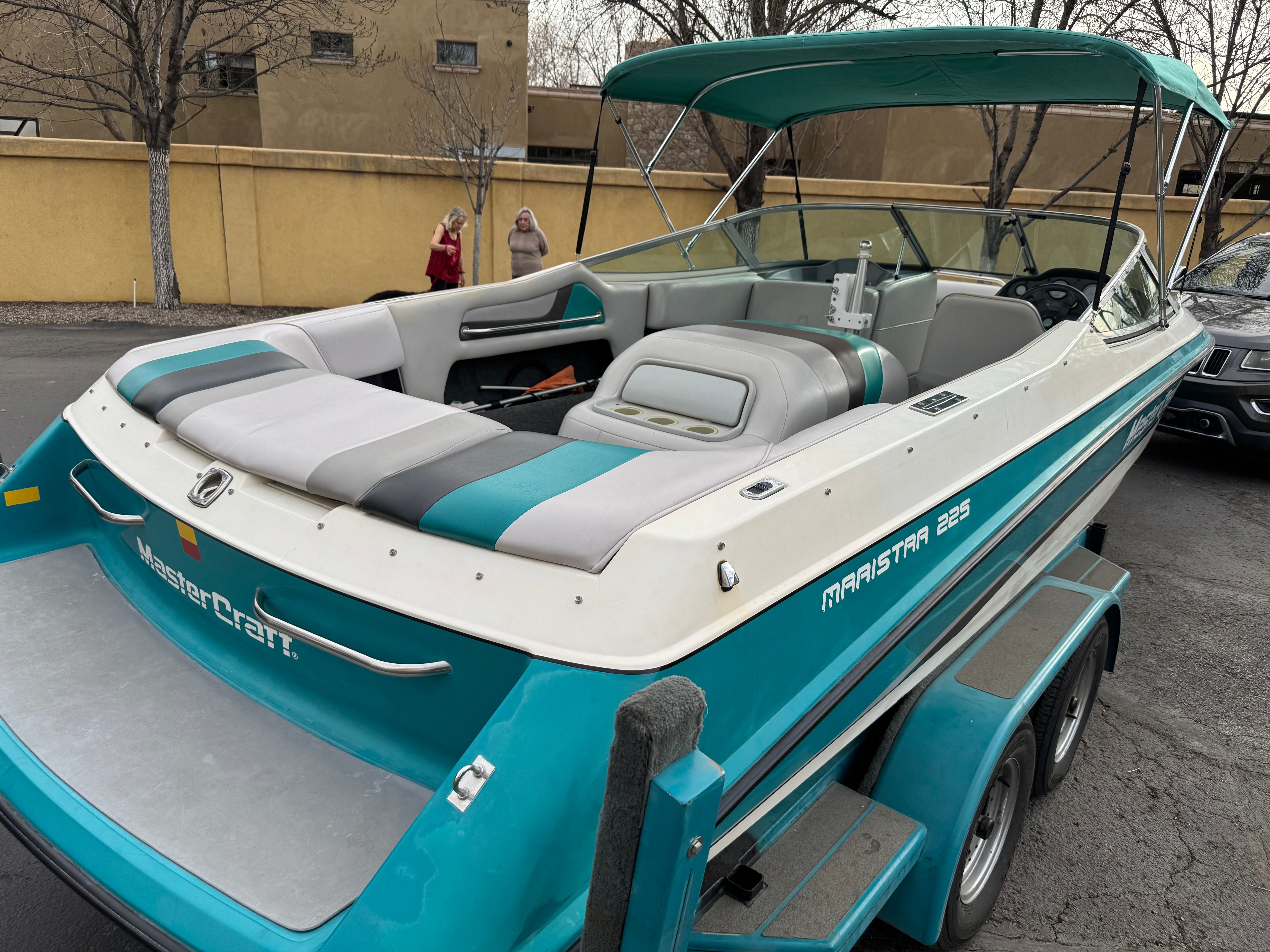 1993 MasterCraft Maristar boat on trailer, turquoise and white.