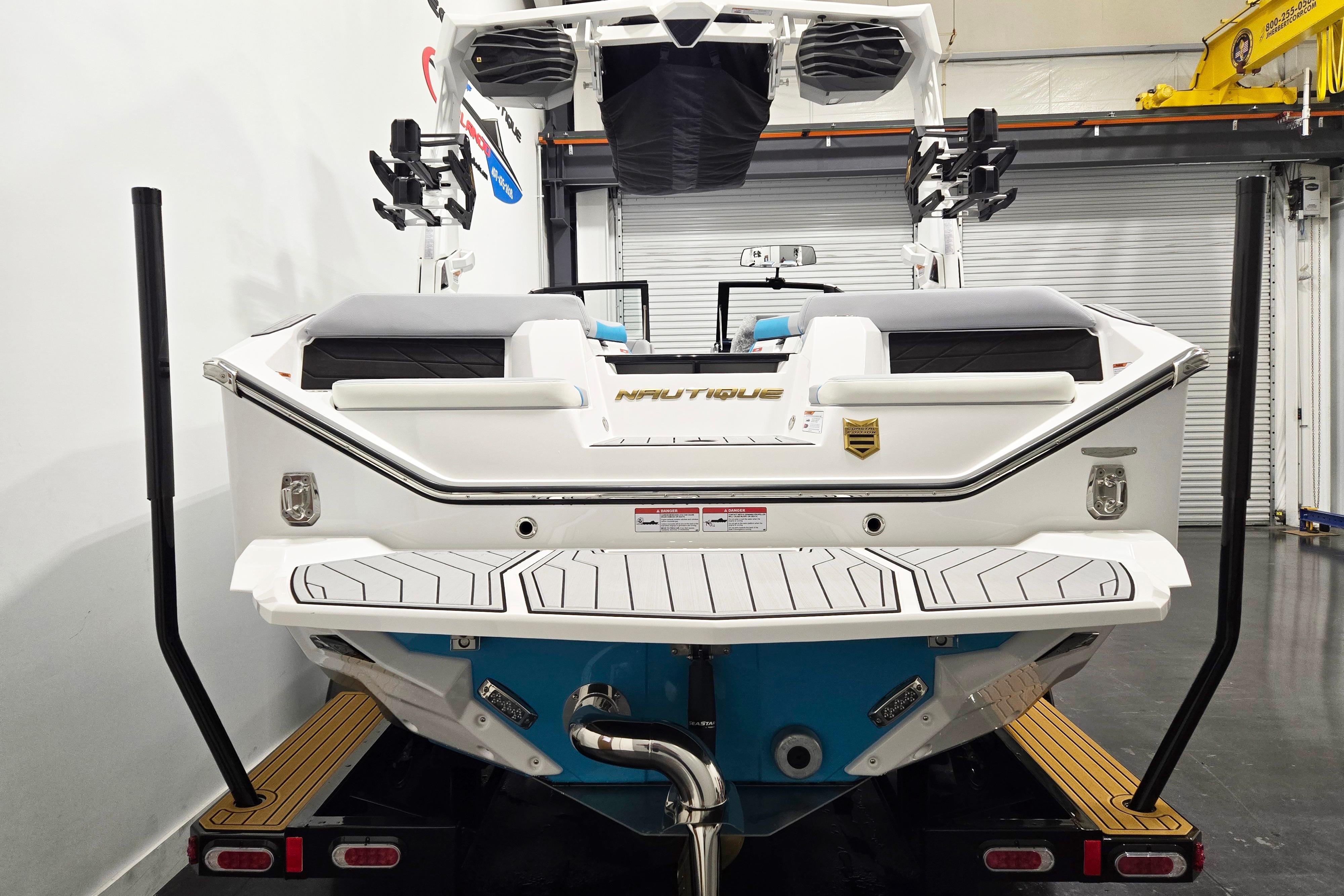 2026 Nautique Super Air Nautique S21 boat in a garage, rear view.