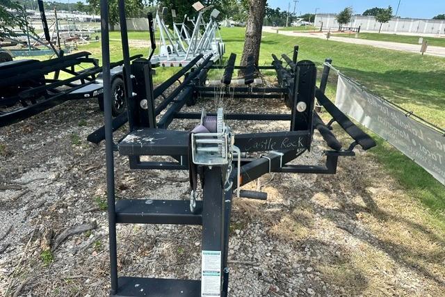 Boat trailer for 2021 Bennington L Bowrider 25 Quad Bench, parked outdoors on gravel.