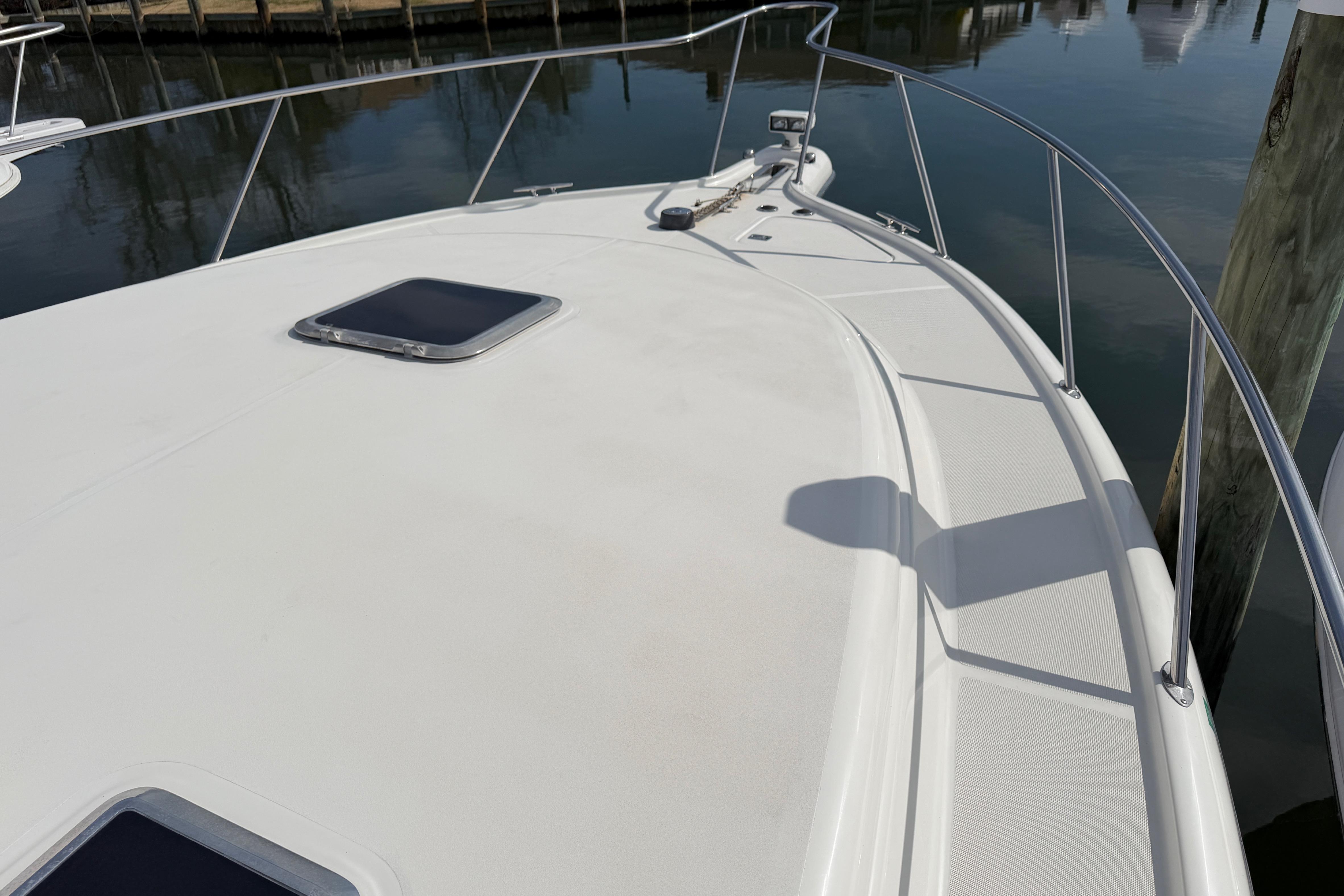 Bow view of a 2004 Tiara 3800 yacht docked at a marina.