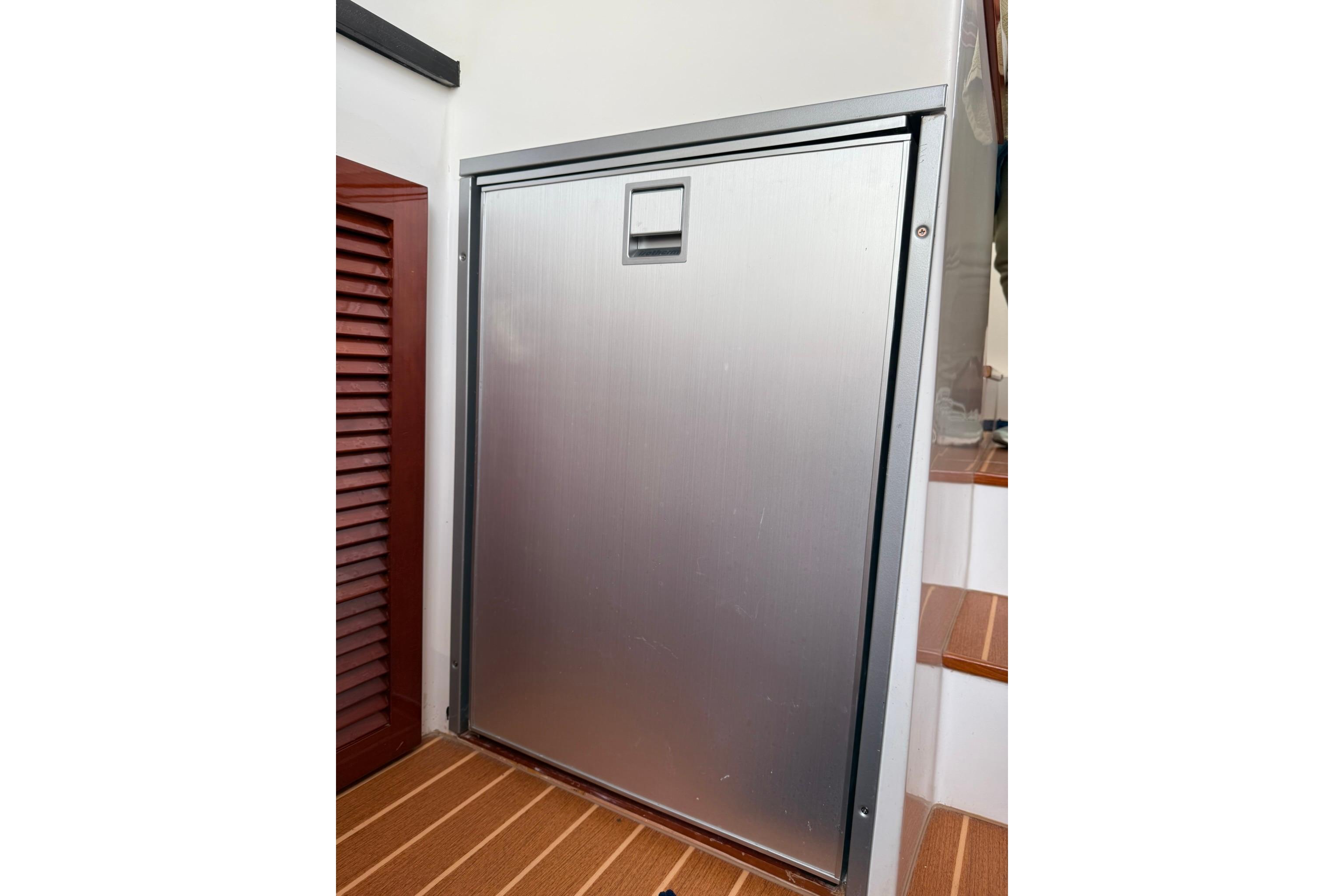 Stainless steel door on 2020 SeaPiper 35 yacht, adjacent to wooden steps.