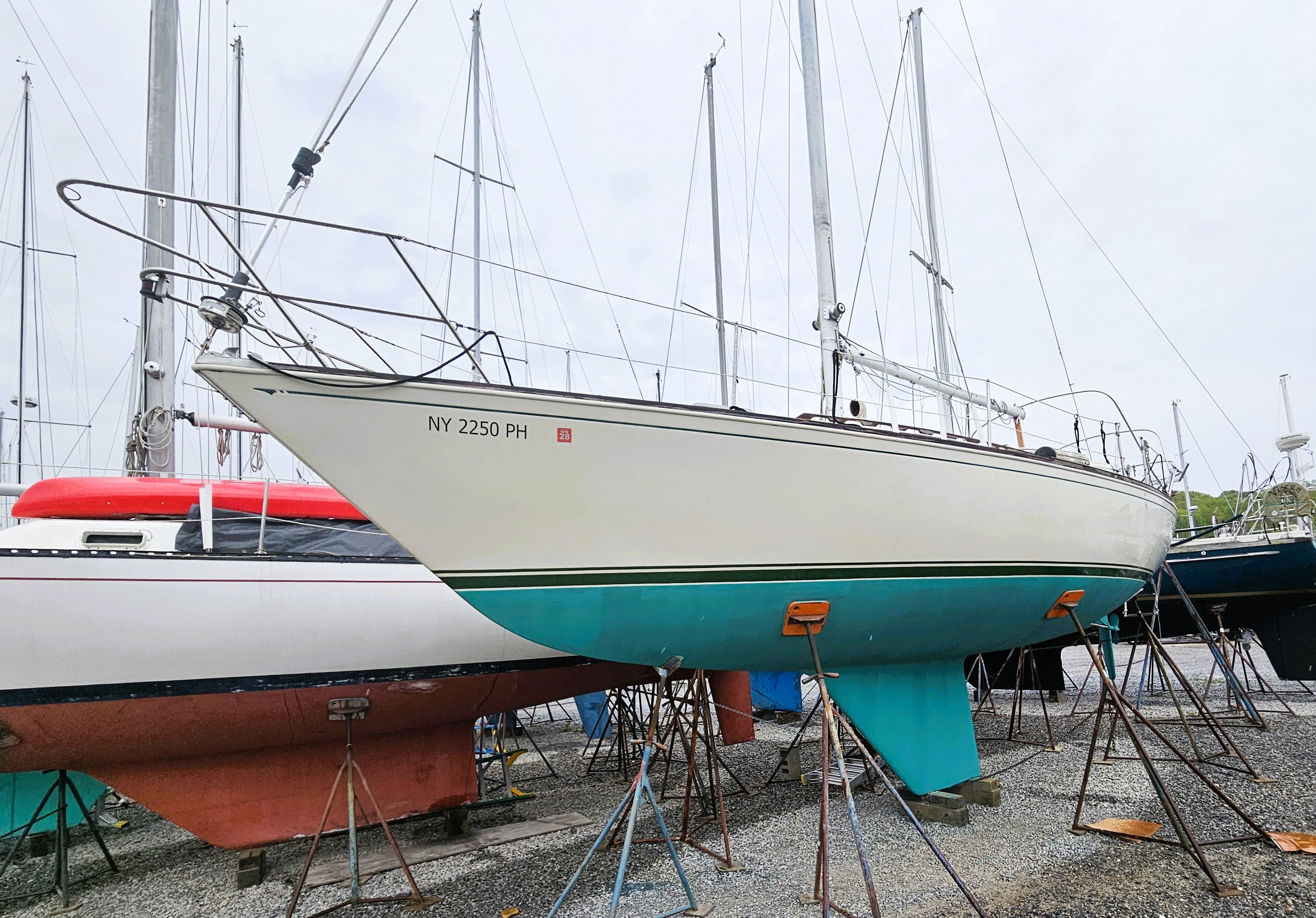 1985 Sabre 34 sailboat on stands in harbor.