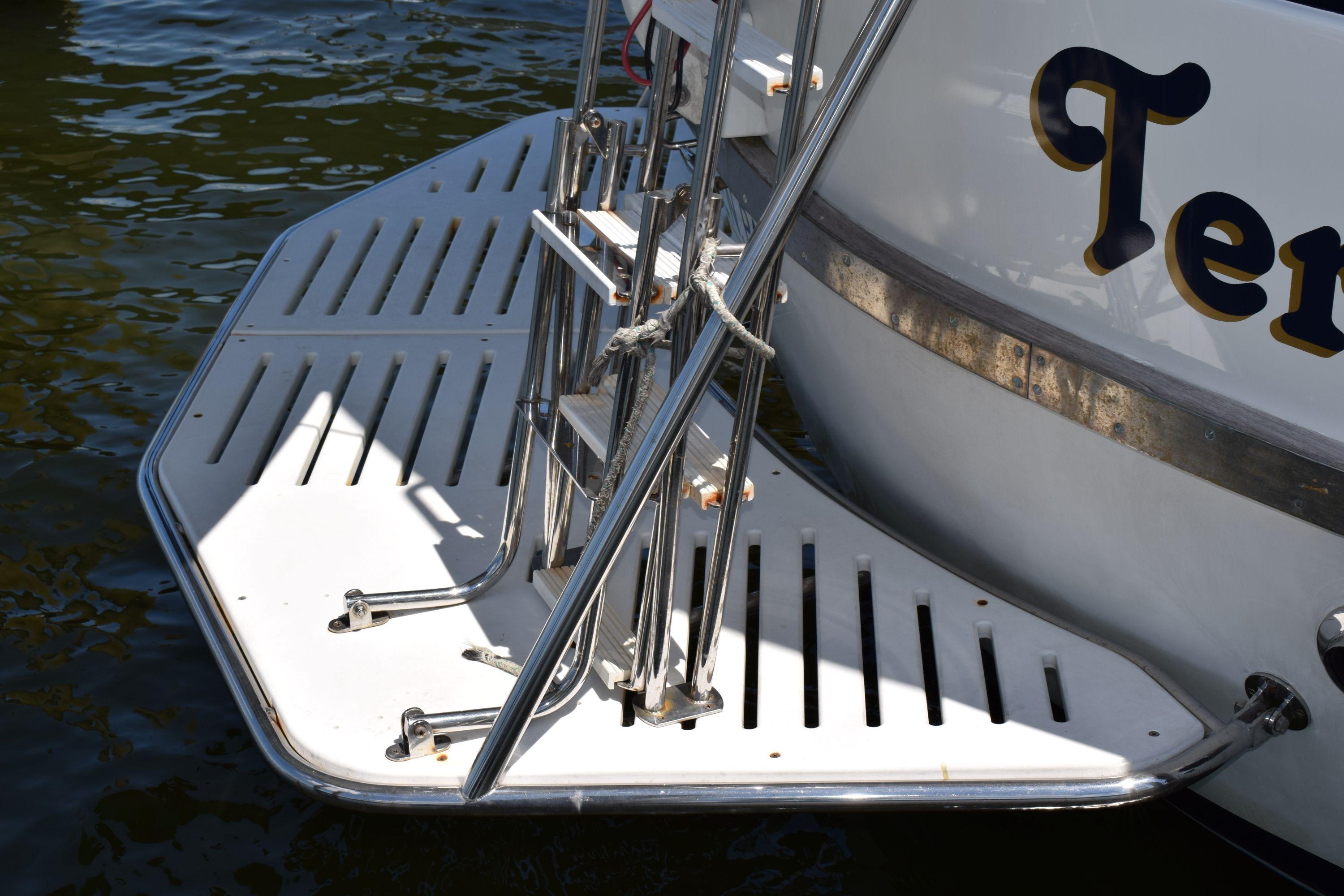 Stern view of 1980 Cheoy Lee 52 Motorsailer with swim platform and ladder.