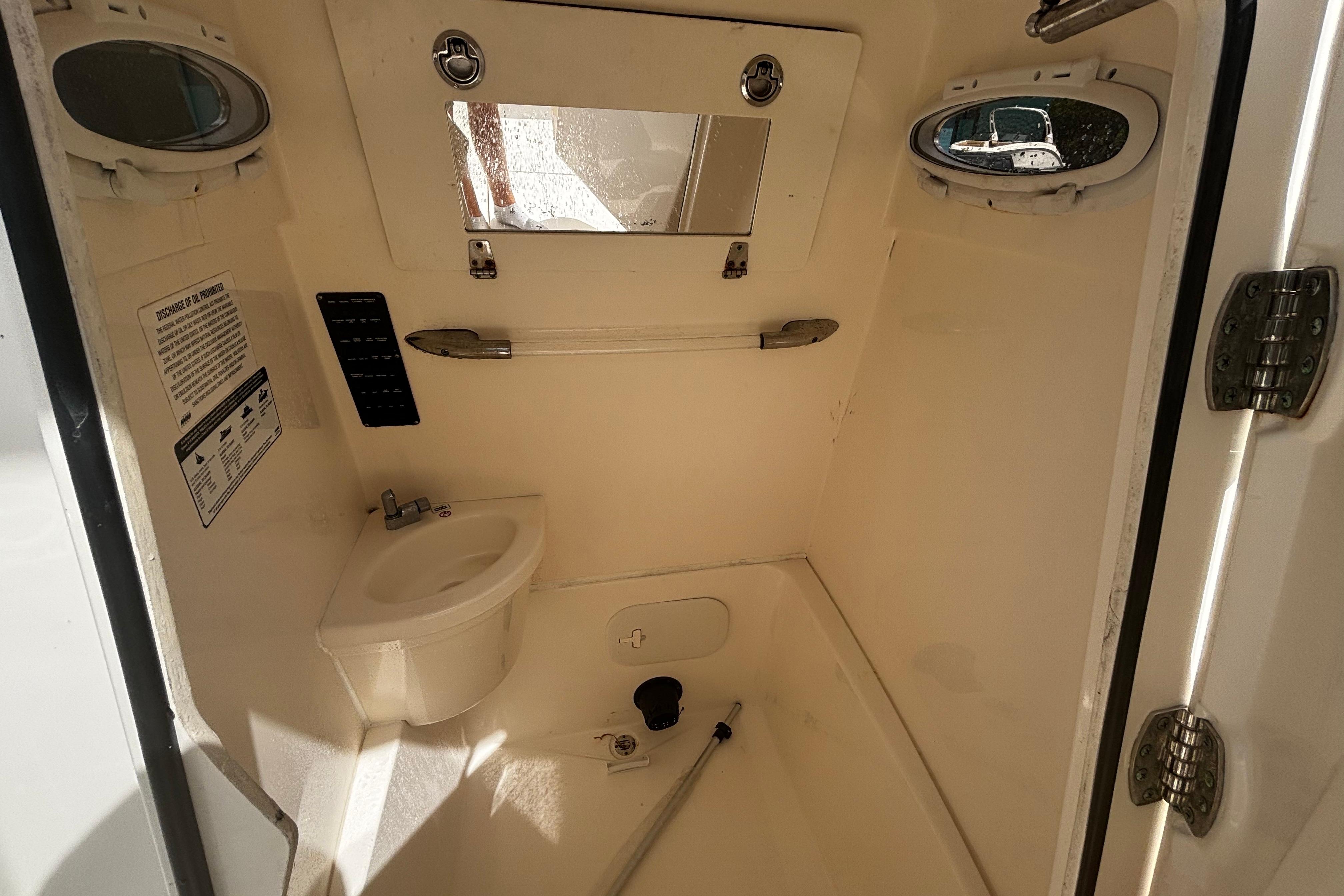 2023 Cobia 262 Center Console boat interior with sink and mirror.