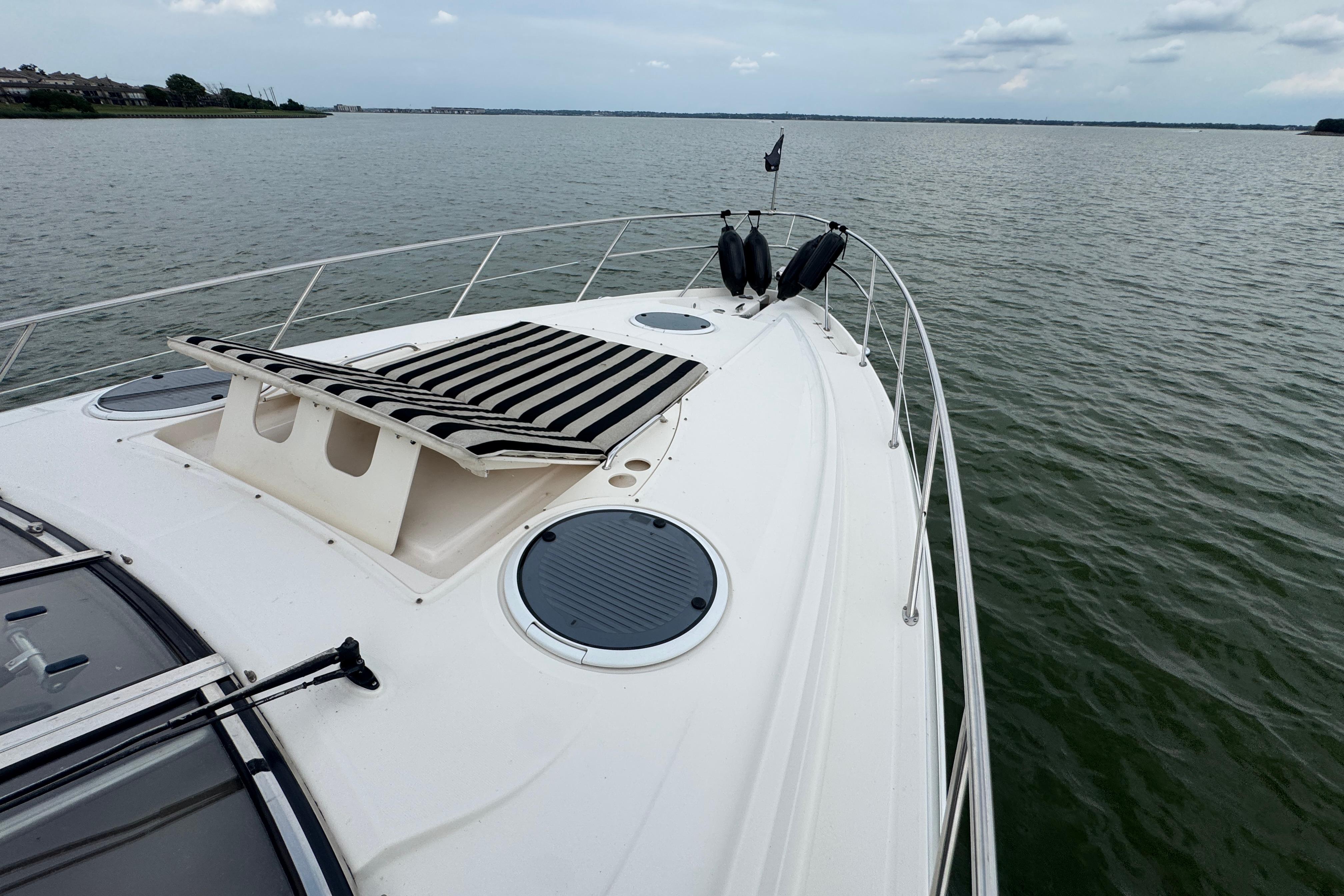 2005 Regal Commodore 4260 yacht on calm waters, featuring a spacious deck and sleek design.