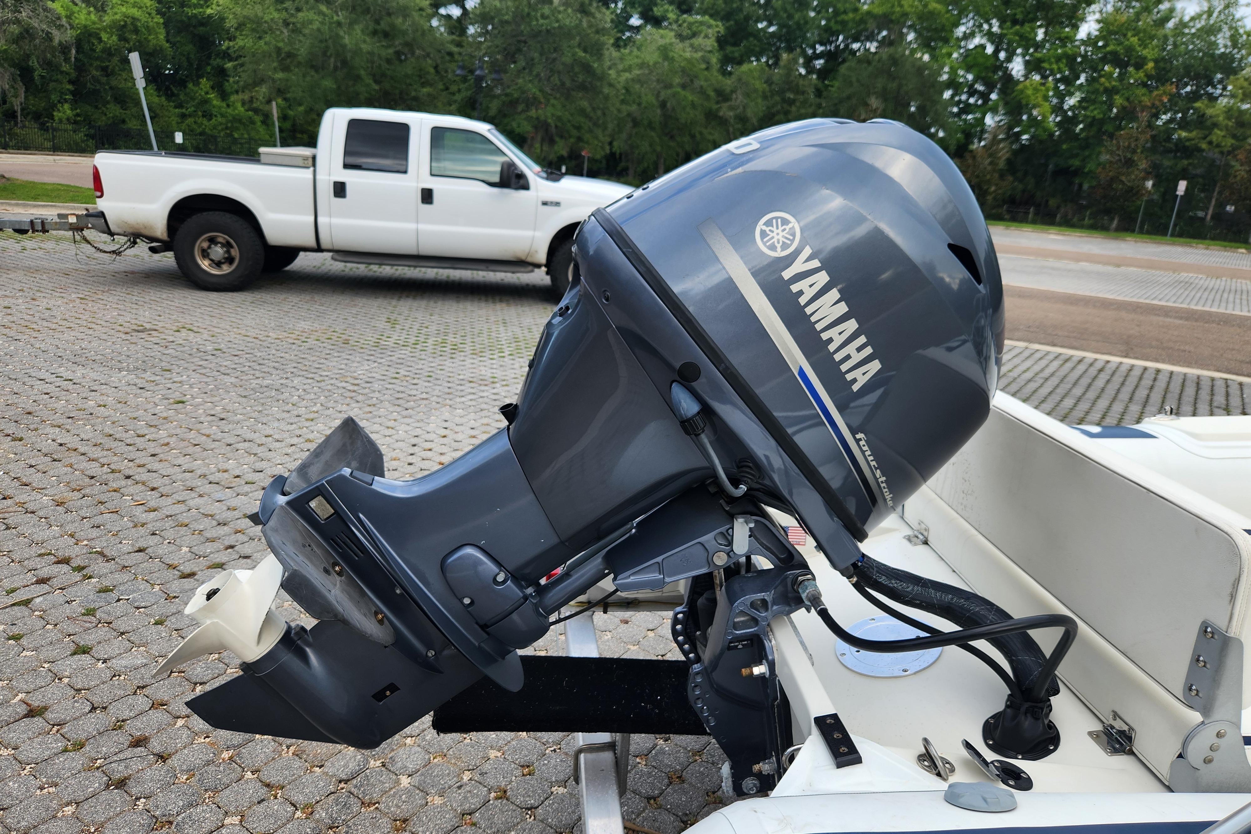 2019 Novurania DL 400 with Yamaha outboard motor, parked near a white pickup truck.