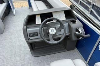 2026 Sun Tracker Party Barge 18 DLX helm with steering wheel and controls.