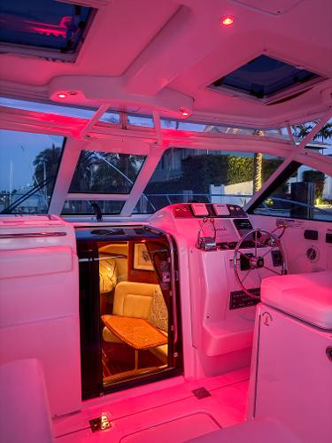 Interior of 2006 Tiara Yachts 3200 Open with ambient red lighting.