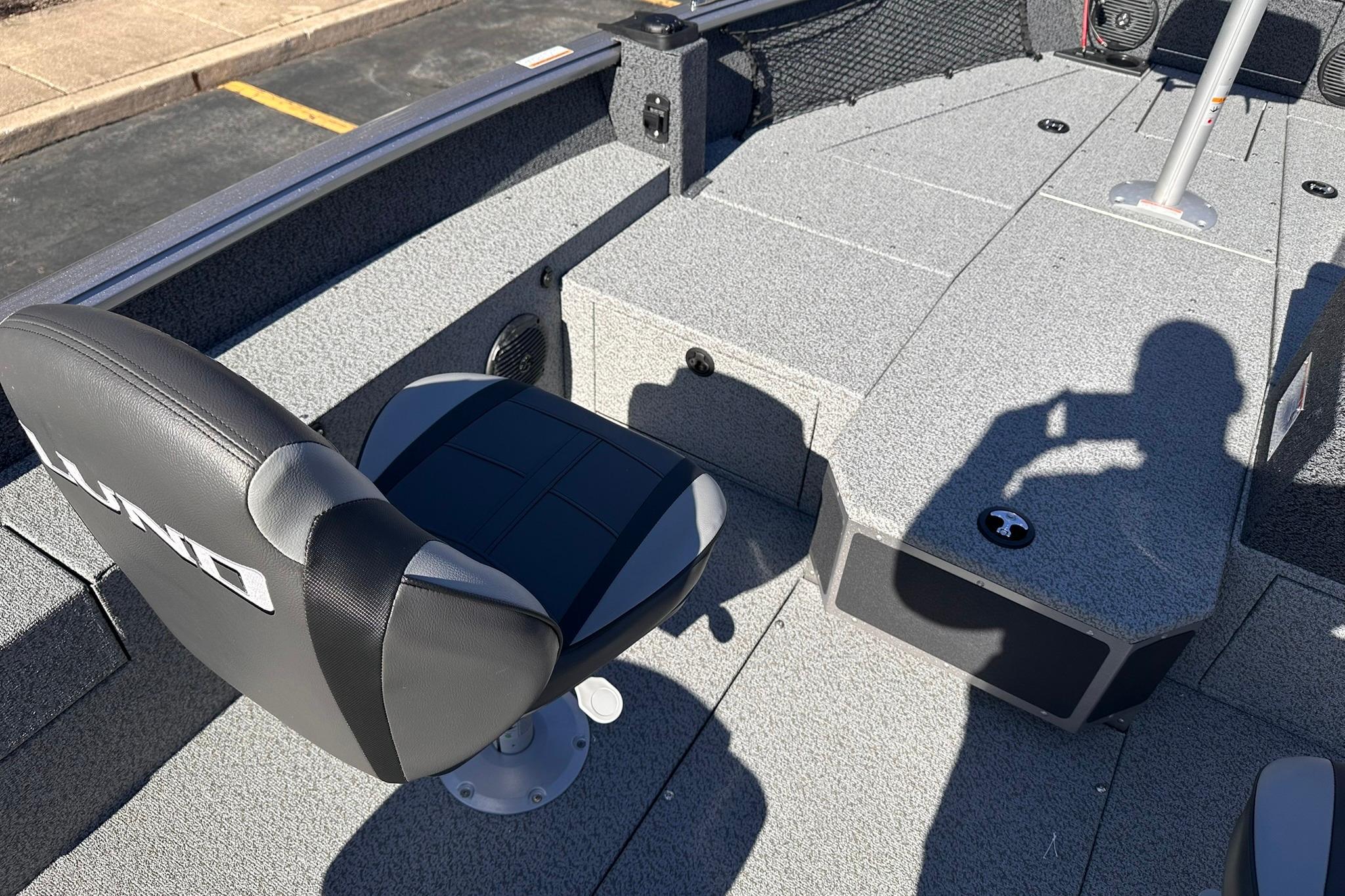 2026 Lund 1875 Impact XS SS boat interior with seating and storage compartments.