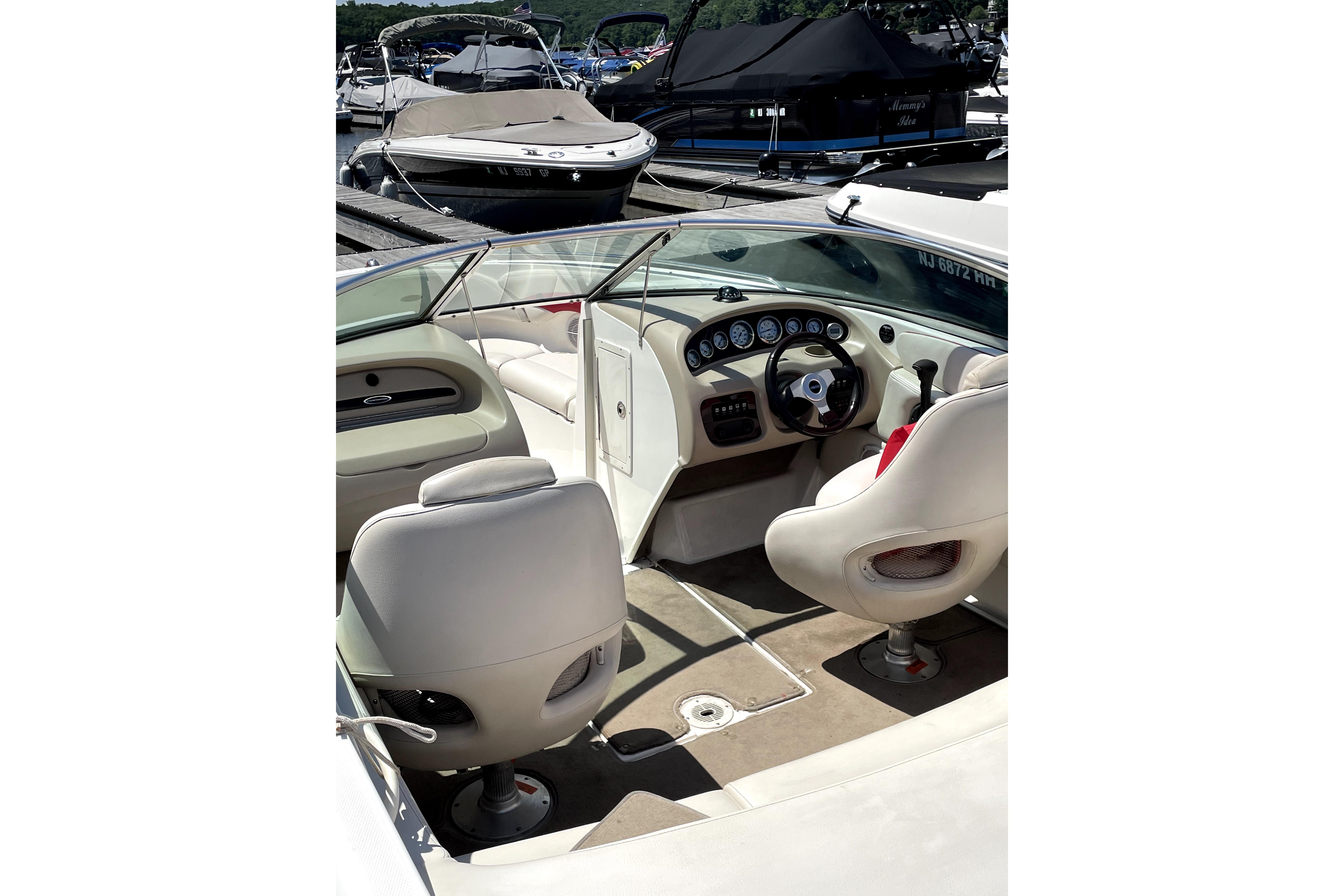 2003 Chaparral 200 SSi boat interior with steering wheel and seating at marina.