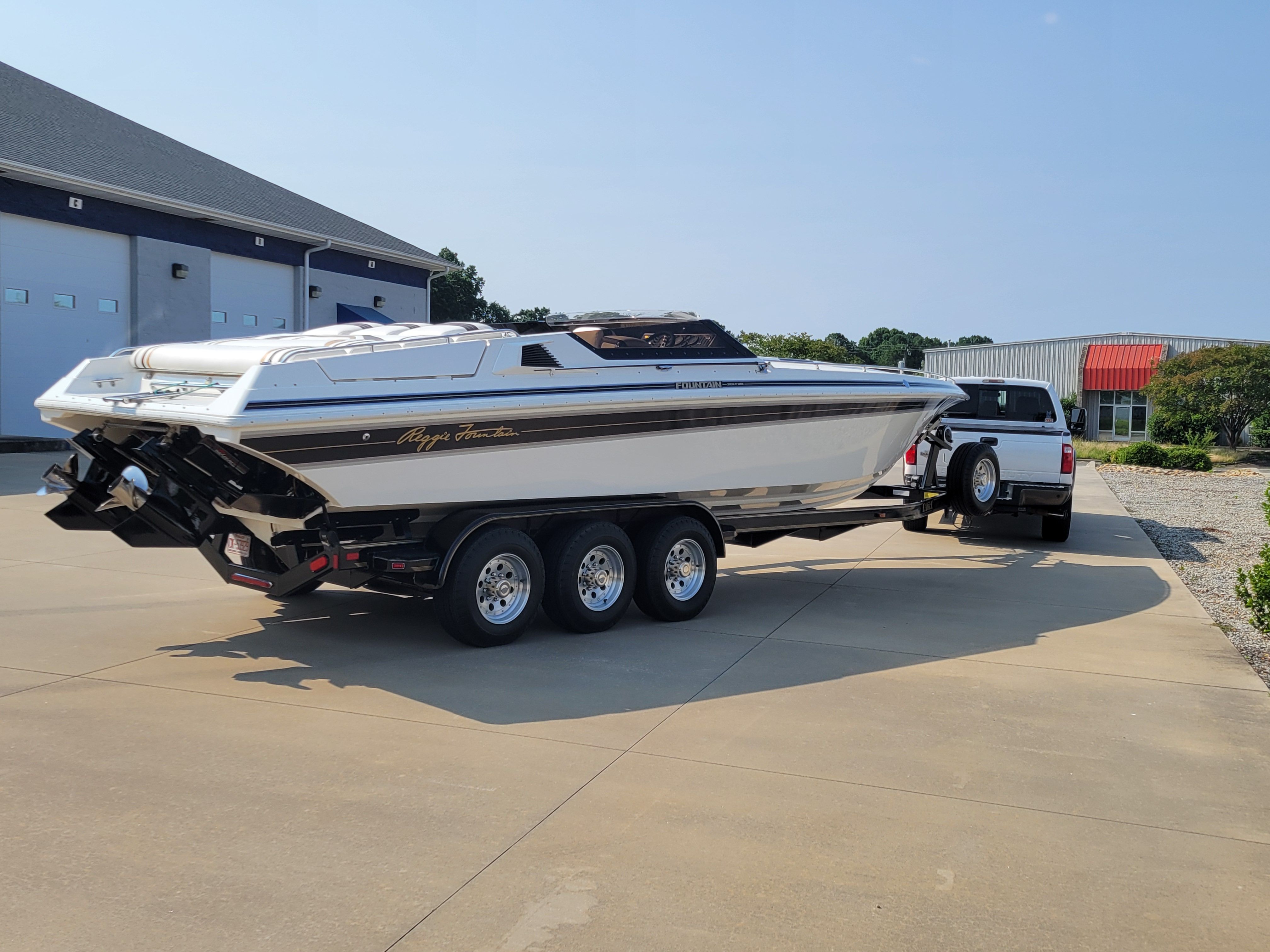1992 Fountain Fever boat on trailer, parked outside a building, ready for transport.