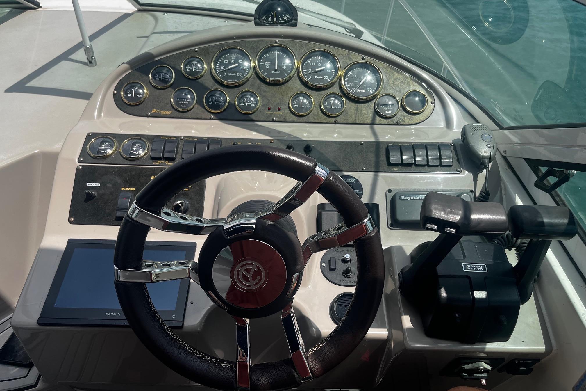 Dashboard of a 2004 Cruisers Yachts 280 CXi Express with steering wheel and control panel.