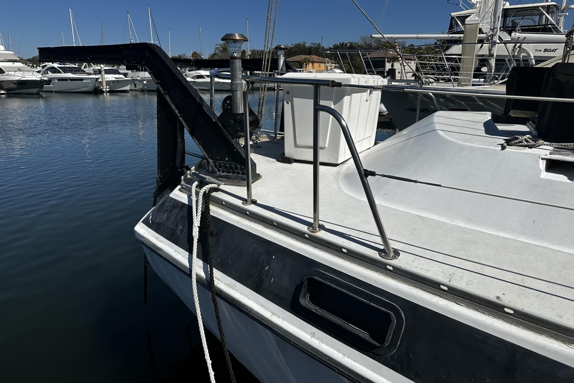 1975 Morgan Out Island 51 sailboat docked in a marina, featuring deck and railing.