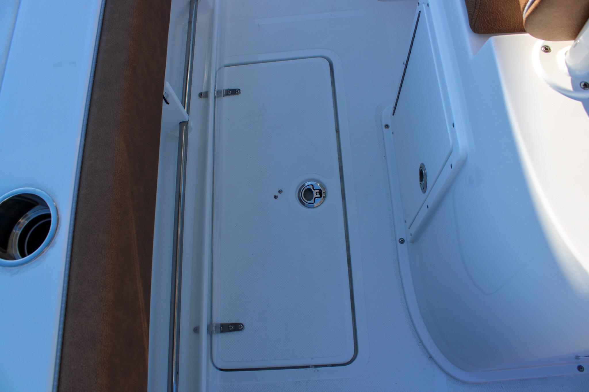 2026 Sea Hunt Gamefish 25 deck with storage compartment and seating area.