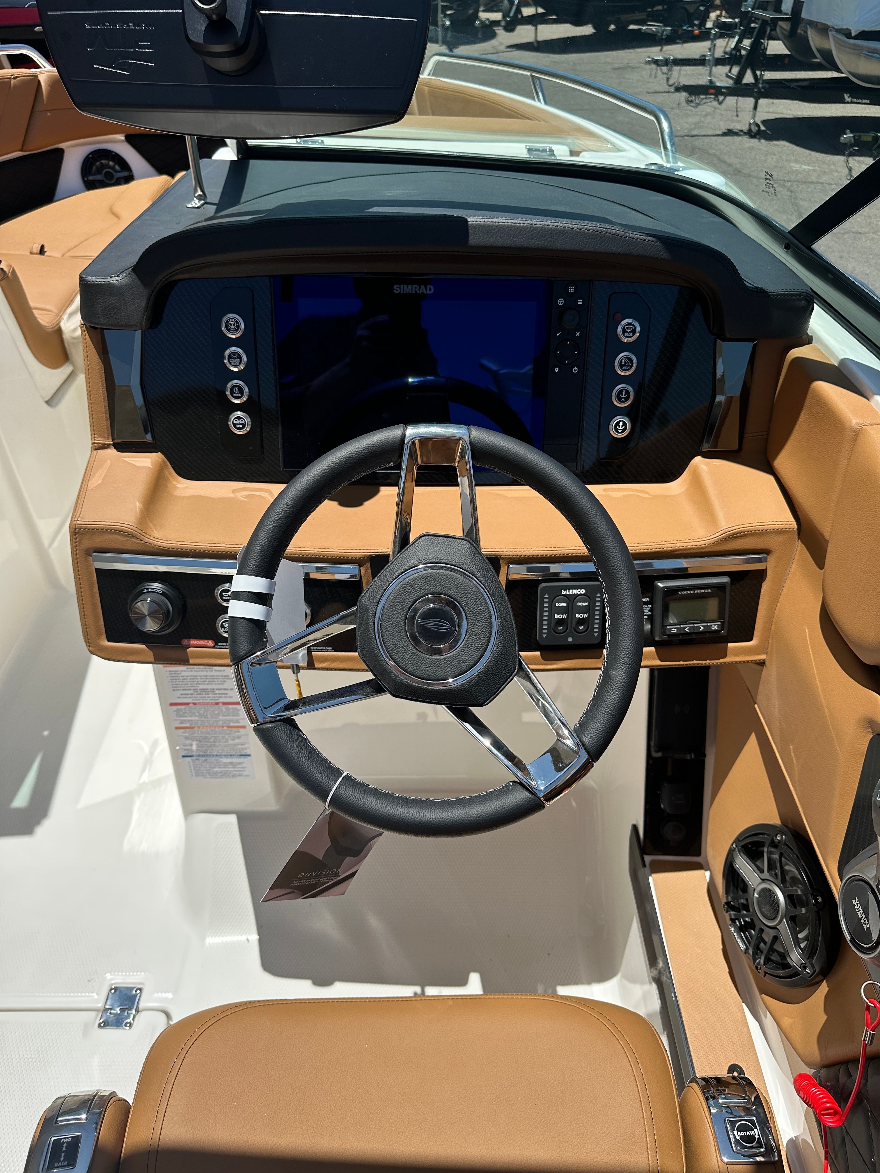 The image shows the cockpit of a Chaparral 26 Surf boat with a modern steering wheel and large display.