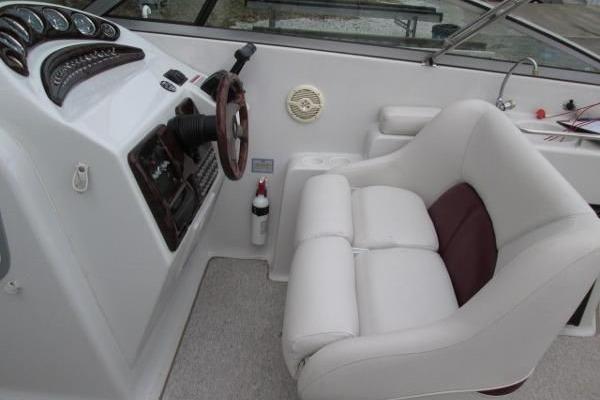 2004 Crownline 288 BR boat interior with white captain's seat and dashboard.