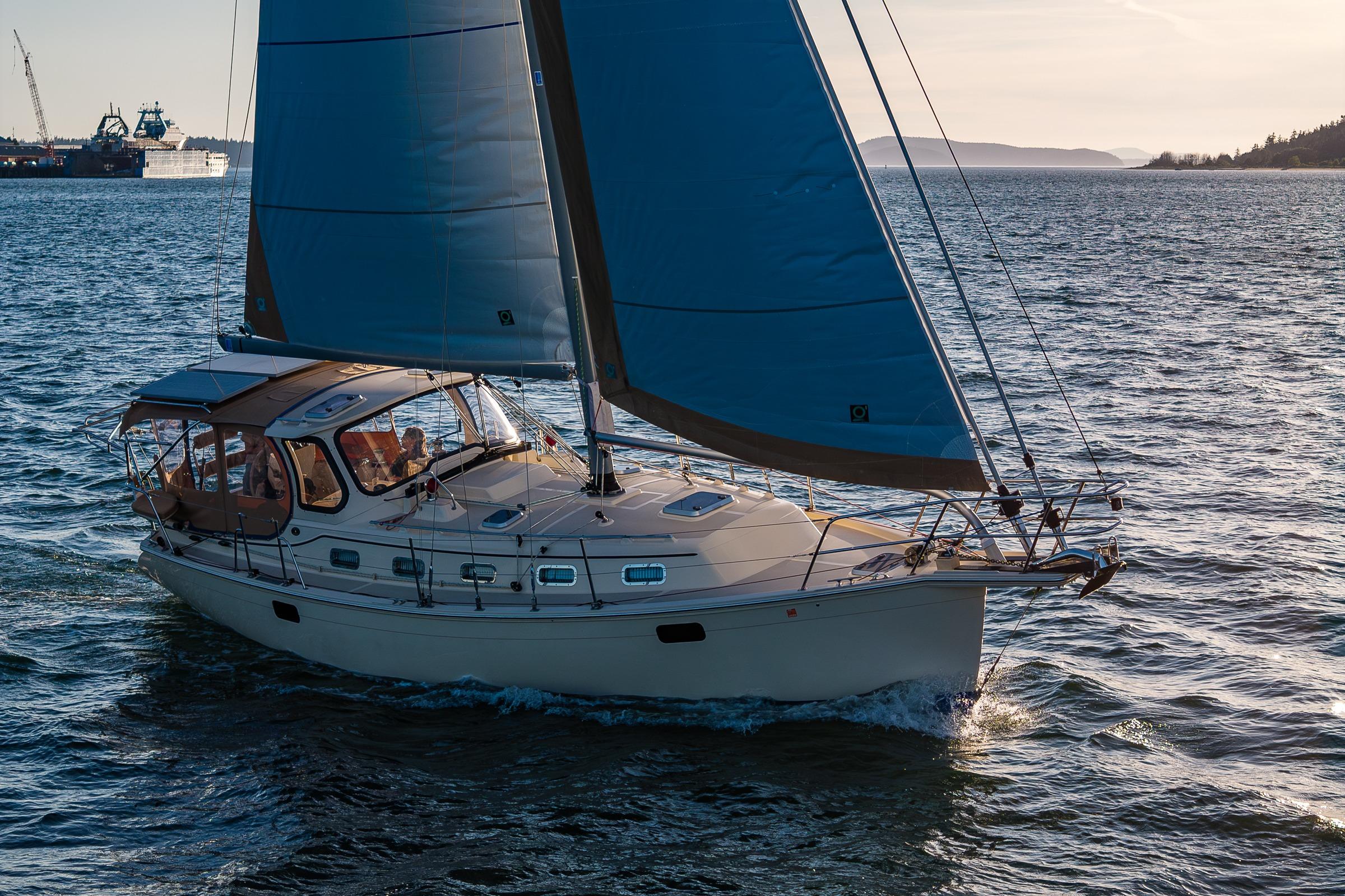 2020 Island Packet 349 sailboat cruising on open water at sunset.