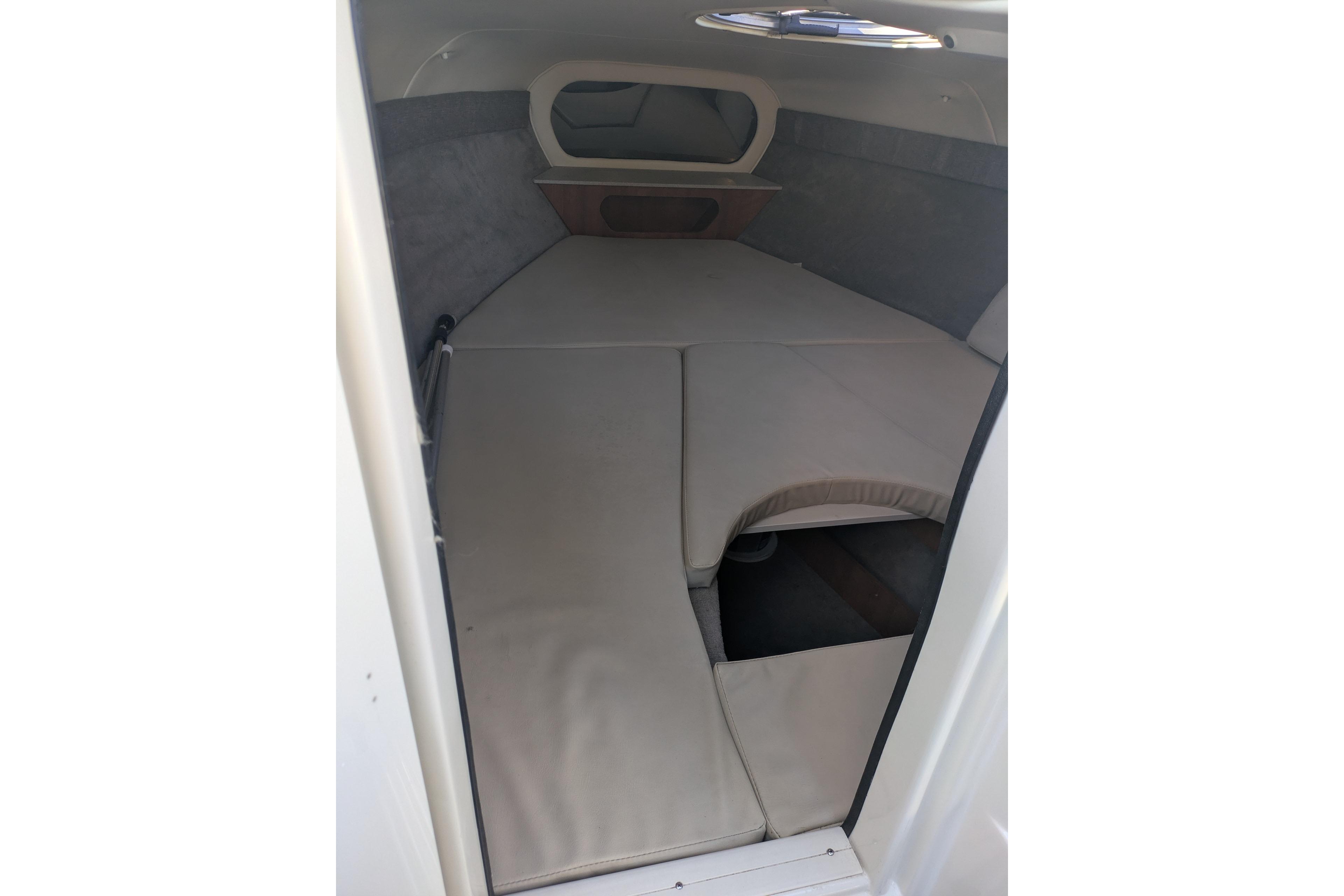 2019 Stingray 250 CR cabin interior with cushioned sleeping area and small window.
