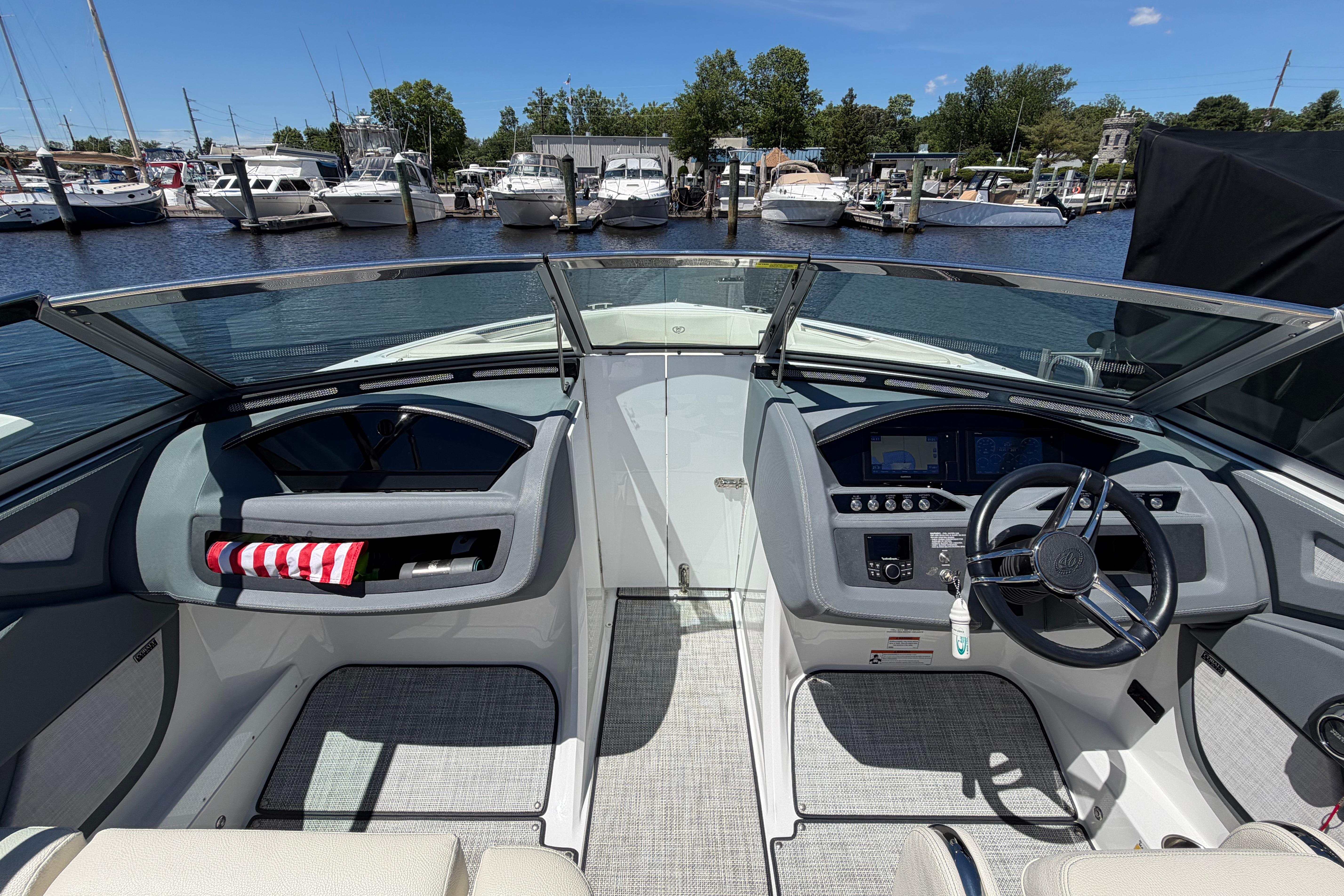 2020 Cobalt R3 boat cockpit with steering wheel, dashboard, and marina view.