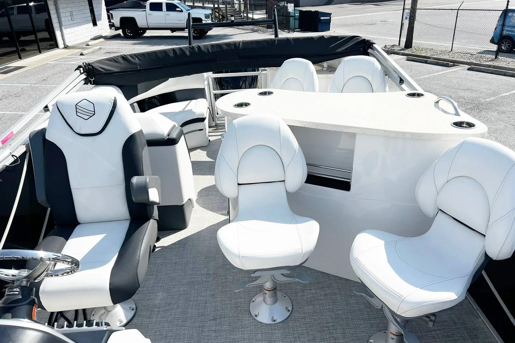 2023 South Bay 523 R boat interior with white seating and steering wheel.