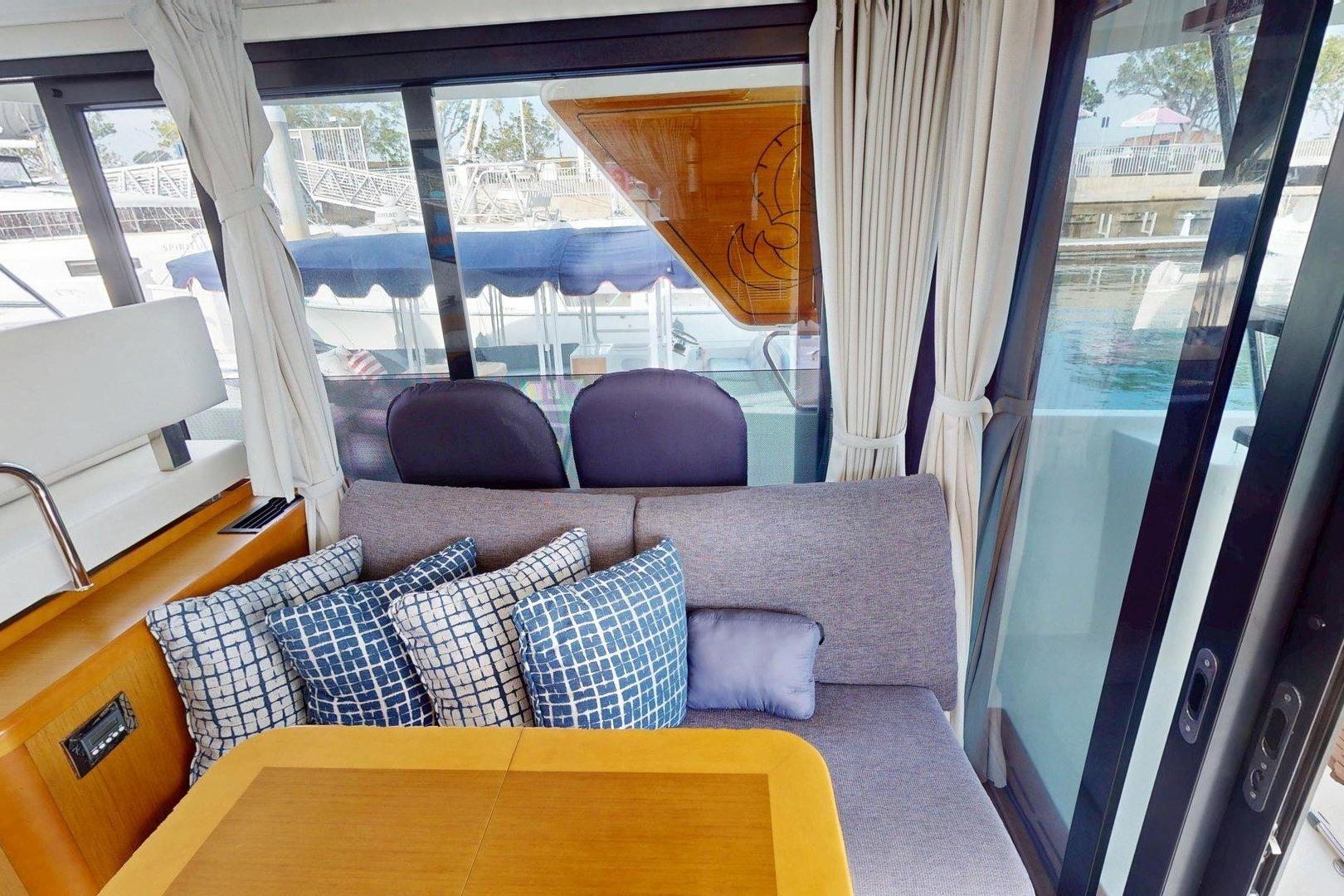 Interior of 2021 Beneteau Swift Trawler 35 with cozy seating and decorative pillows.