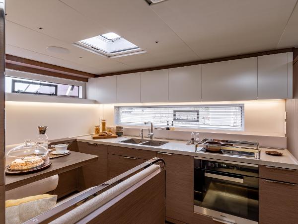 Modern kitchen interior of 2025 Lagoon SIXTY 7 yacht, featuring sleek design and appliances.