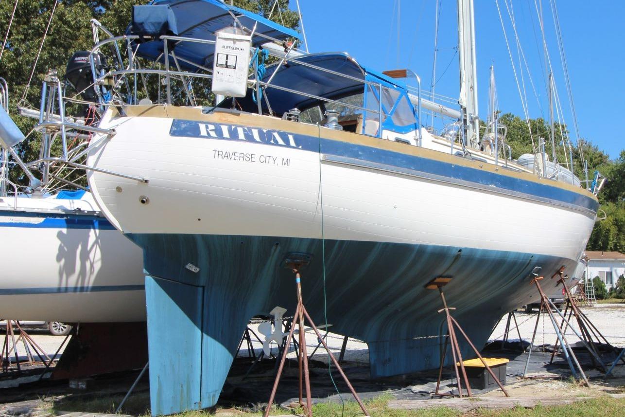 1987 Slocum 43 sailboat on stands, Traverse City, MI, with blue and white hull.
