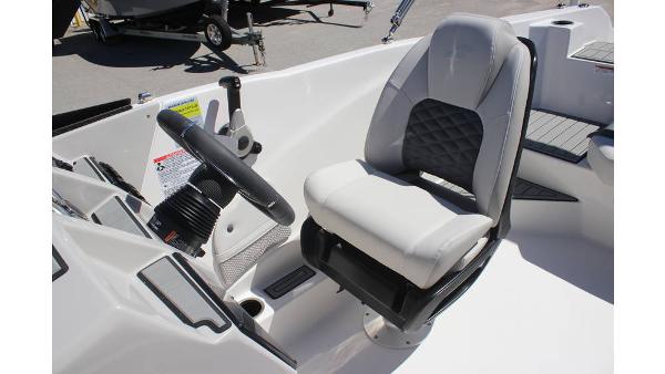 2025 Starcraft SVX 210 OB DC boat interior with steering wheel and cushioned seat.
