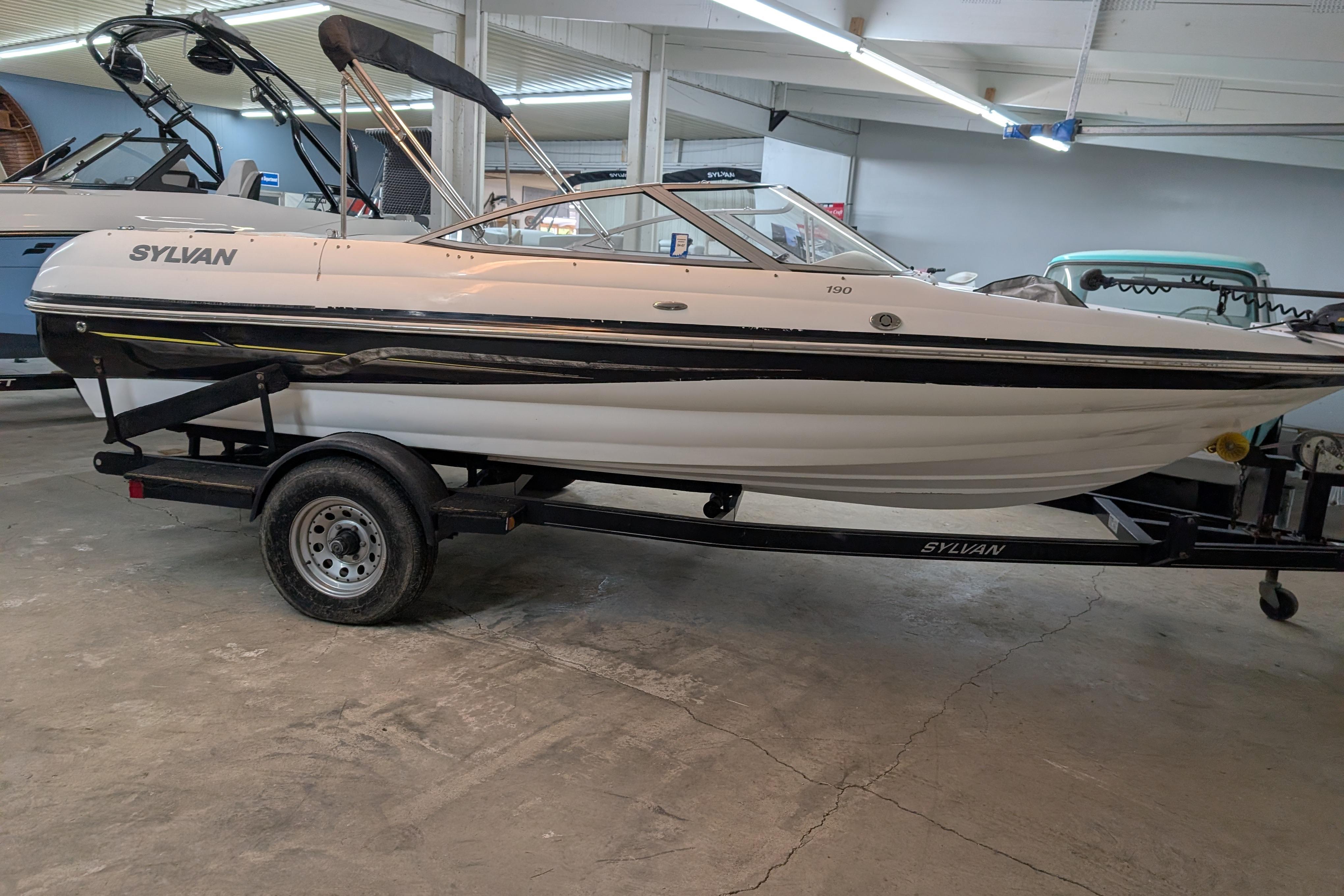 2005 Sylvan V190 I/O boat on trailer in indoor showroom.